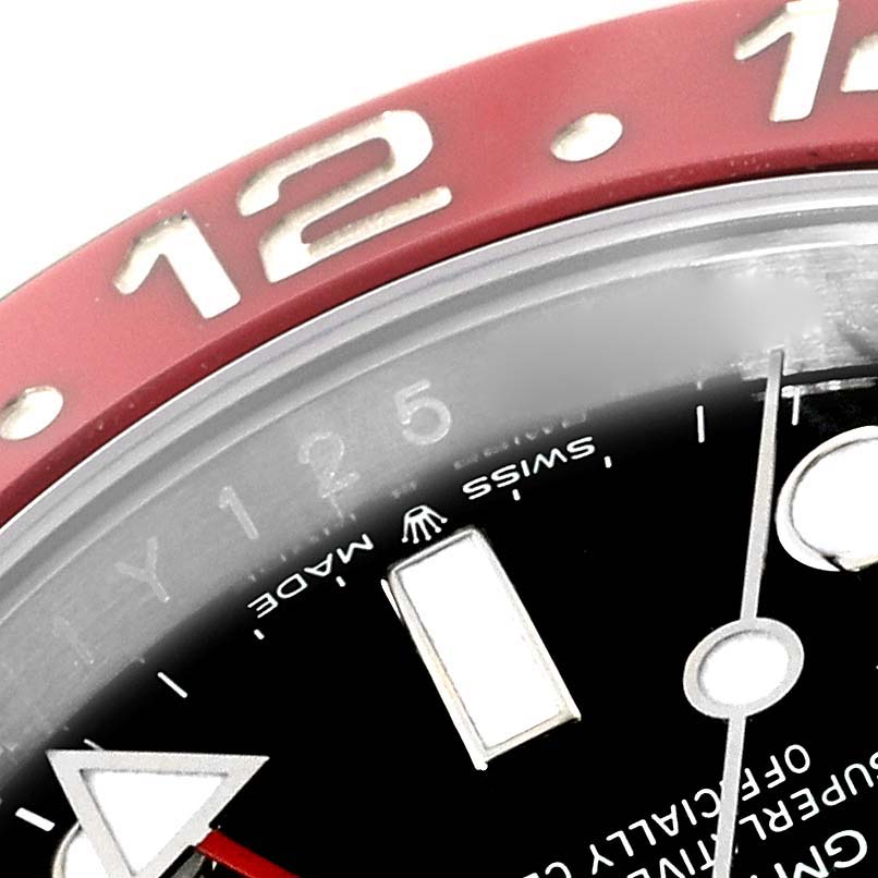 This close-up shot of a Rolex GMT-Master 126710BLRO Men
s Stainless Steel Black Dial 126710BLRO Men
s Stainless Steel Black Dial displays part of the bezel, hour markers, and text on the dial.