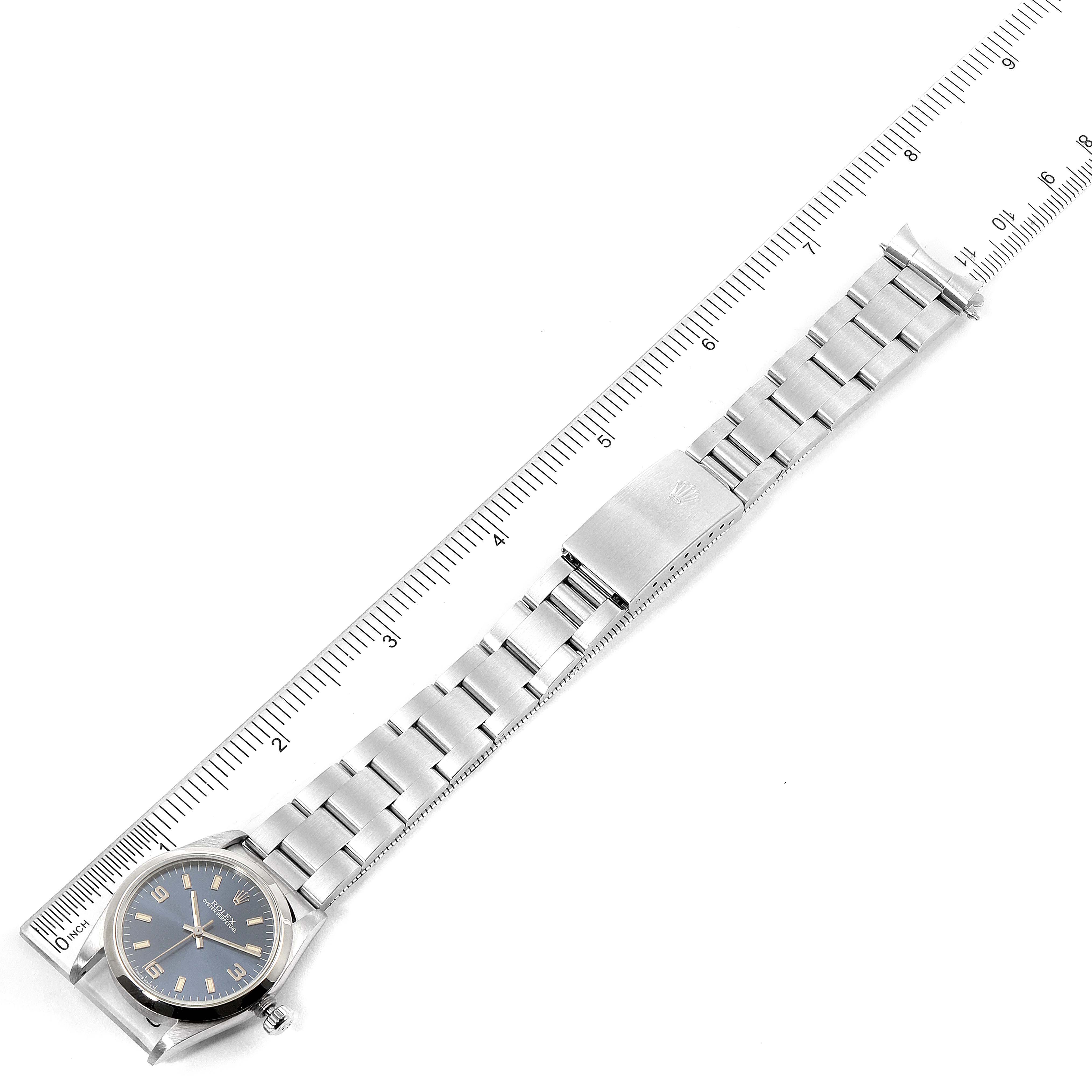 The image shows a top-down view of a Mid-Size Rolex watch, displaying the face, bracelet, and clasp alongside a ruler for scale.