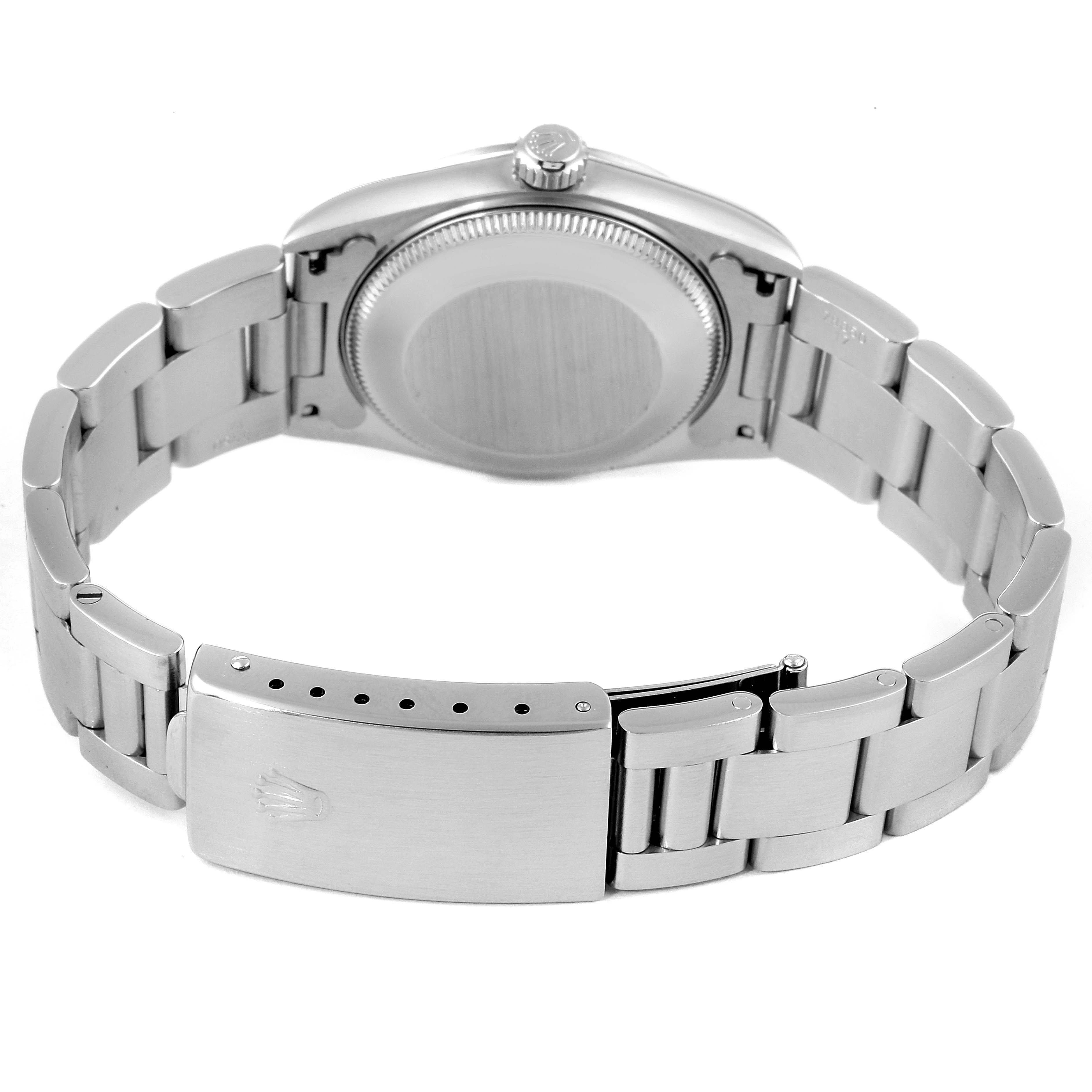 The image shows the back view of the case and the clasp of a Mid-Size Rolex watch.