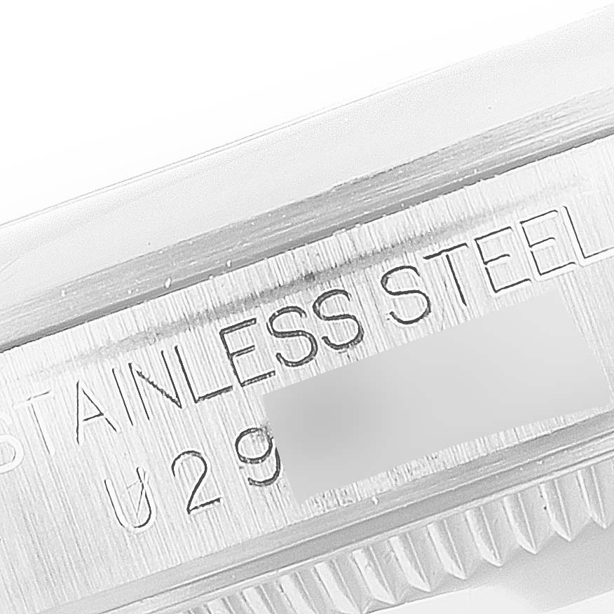 Close-up of the side of a Rolex Mid-Size 67480 Women's Stainless Steel Blue Dial 67480 Women's Stainless Steel Blue Dial watch showing the "STAINLESS STEEL" engraving and partial serial number.