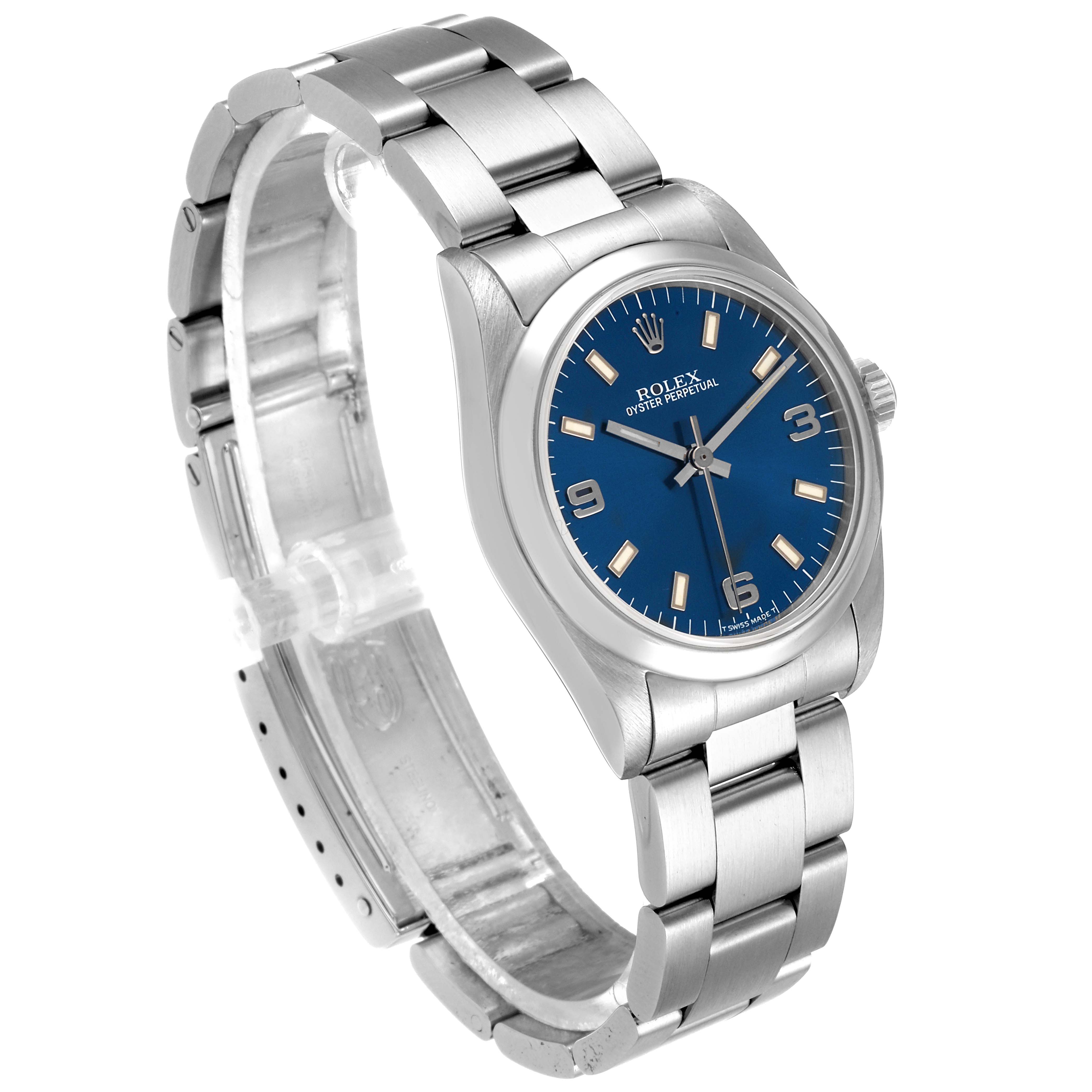 The image shows a side angle view of the Mid-Size Rolex Oyster Perpetual watch, highlighting its blue dial and stainless steel bracelet.
