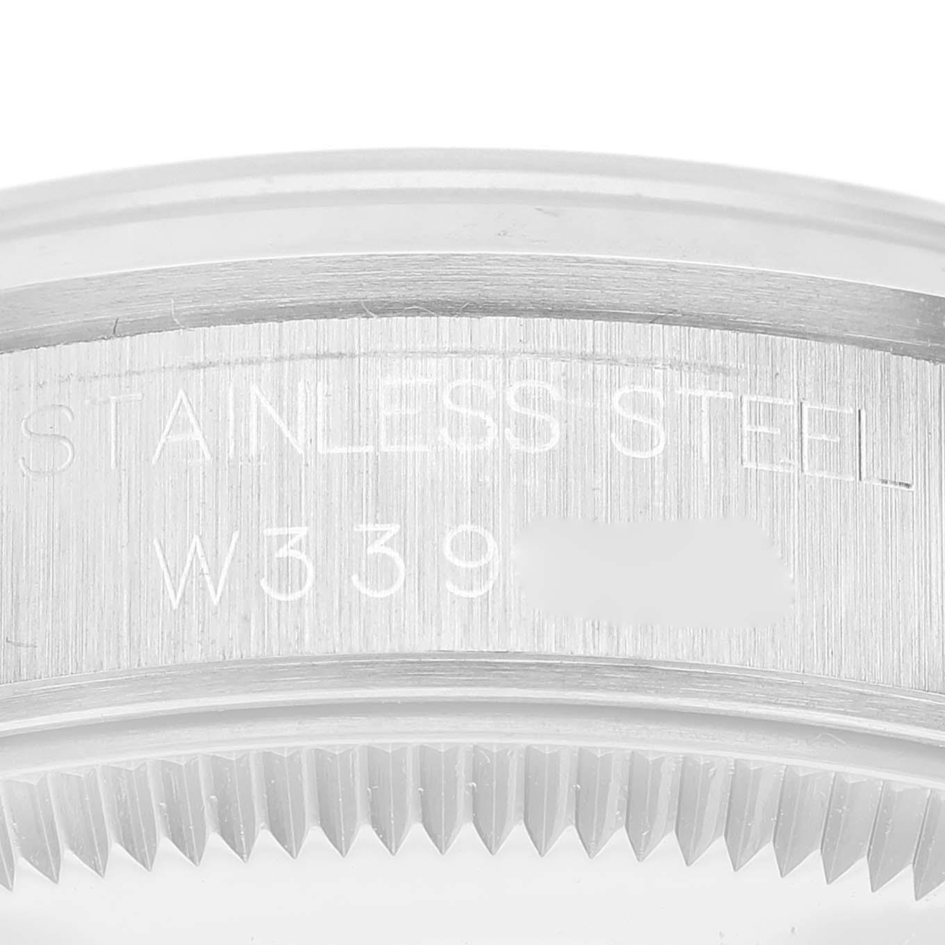 This close-up image shows the stainless steel case back and serial number of a Rolex Mid-Size 68240 Women's Stainless Steel Black Dial 68240 Women's Stainless Steel Black Dial model.