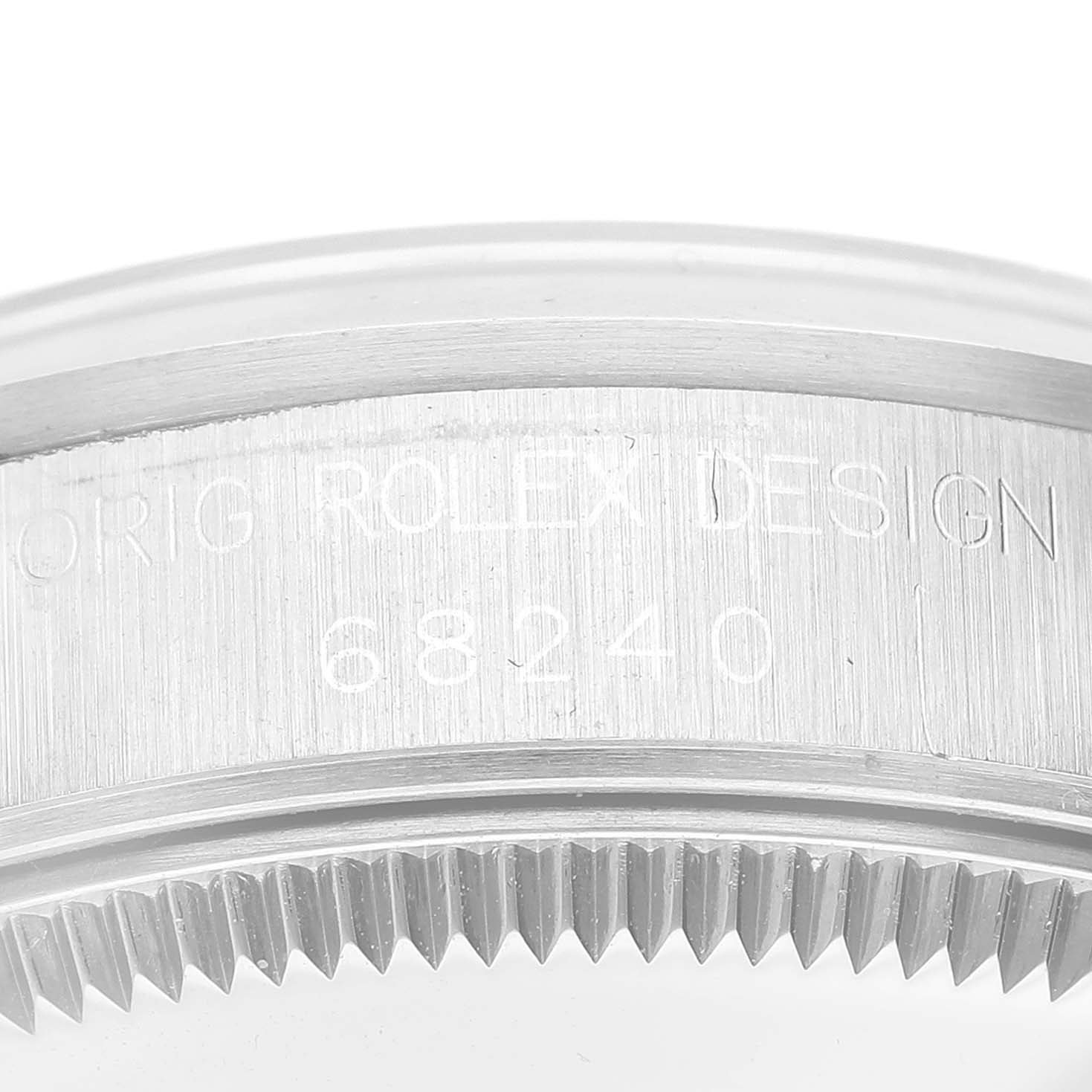 The image shows a close-up of the engraved case and grooved bezel of a Mid-Size Rolex watch, model 68240.