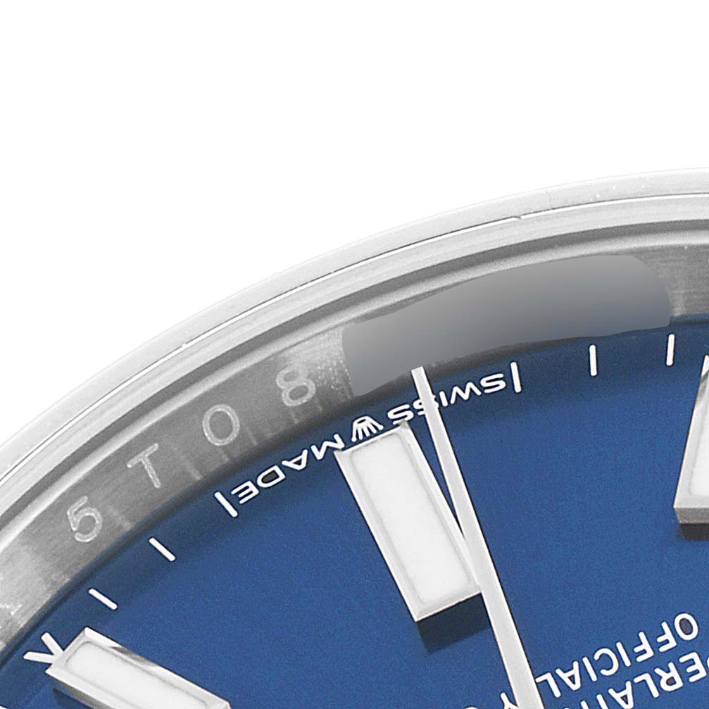 The image shows a close-up angled view of the dial edge and markers of an Oyster Perpetual model by Rolex.