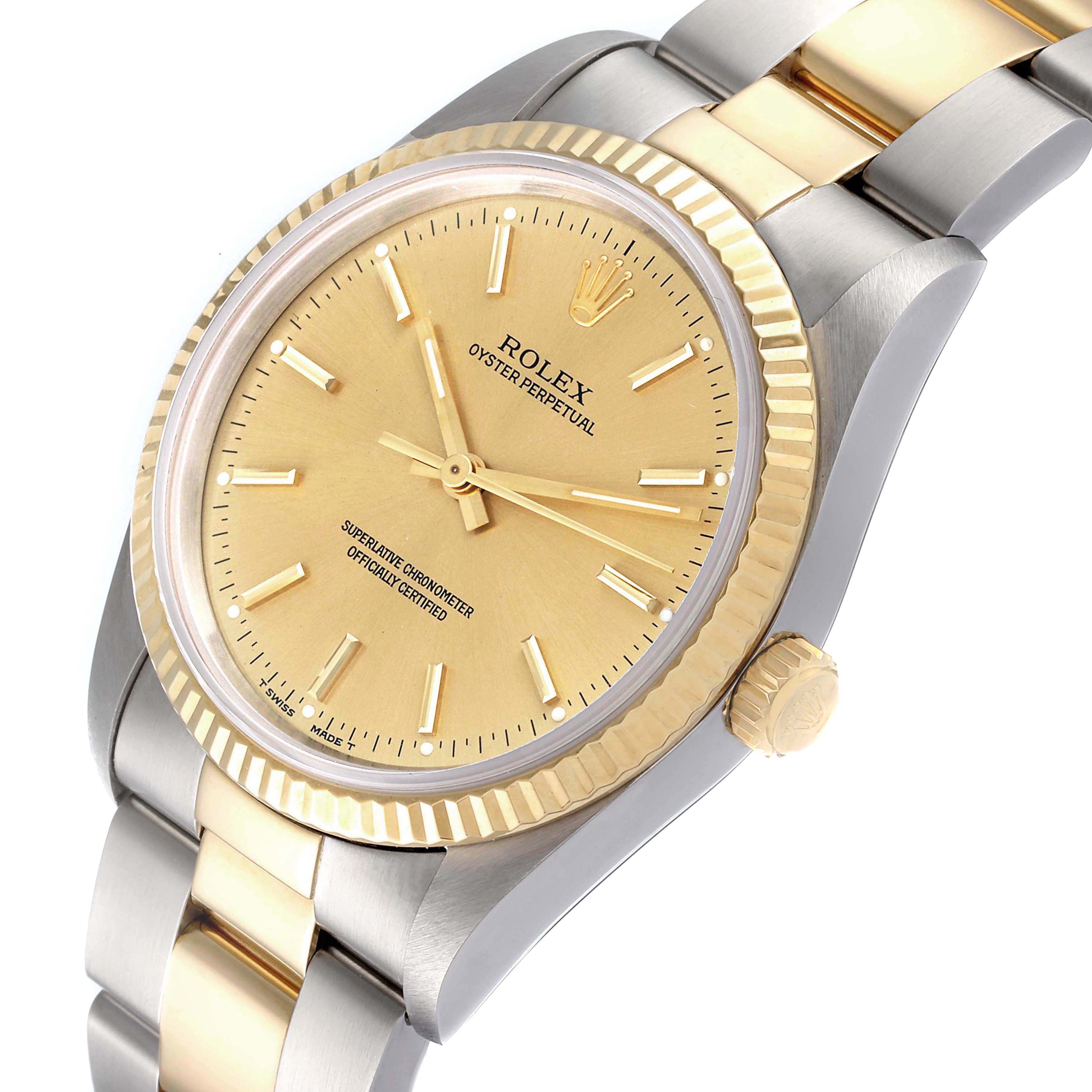The Rolex Oyster Perpetual 14233 Men
s Steel and Gold (two tone) Champagne Dial 14233 Men
s Steel and Gold (two tone) Champagne Dial watch is shown at a slight angle, displaying its gold face, fluted bezel, and two-tone bracelet.