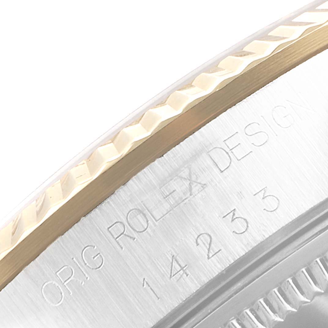 This image shows a close-up of the bezel and serial number engraving on the side of the Rolex Oyster Perpetual 14233 Men
s Steel and Gold (two tone) Champagne Dial 14233 Men
s Steel and Gold (two tone) Champagne Dial watch.