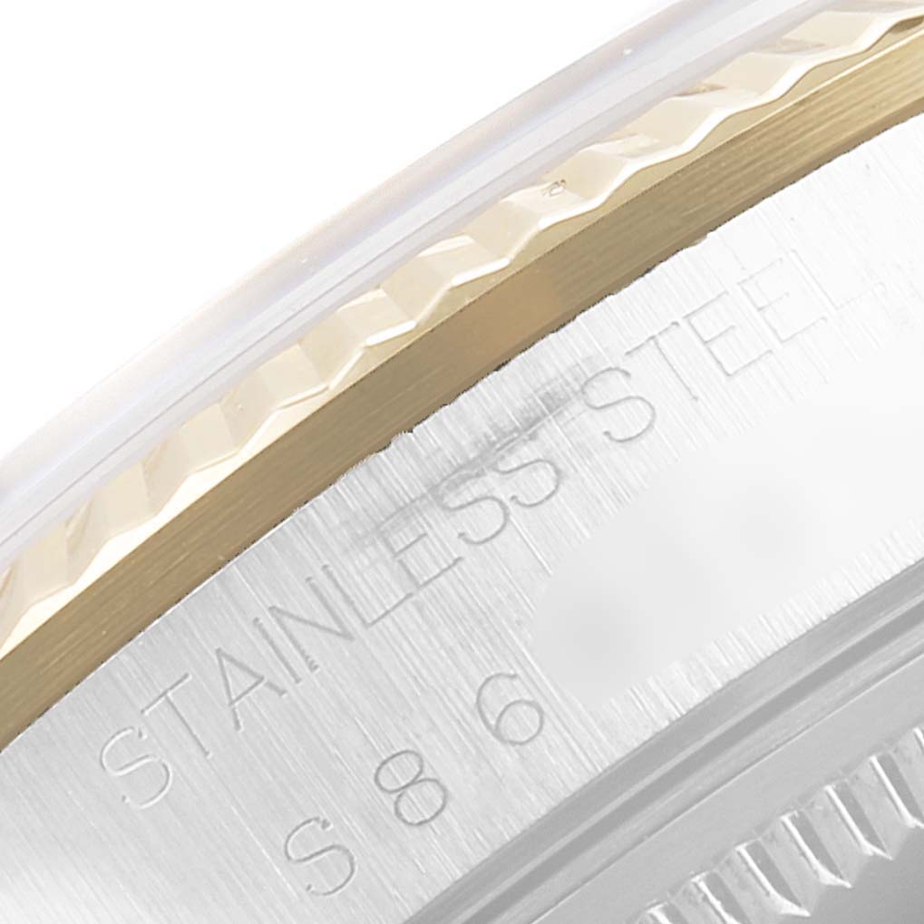 This image shows a close-up of the engraved stainless steel case and fluted bezel of a Rolex Oyster Perpetual 14233 Men
s Steel and Gold (two tone) Champagne Dial 14233 Men
s Steel and Gold (two tone) Champagne Dial watch.