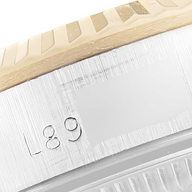 Close-up view of the bezel and serial number engraving on a Rolex Oyster Perpetual 67193 Women
s Steel and Gold (two tone) White Dial 67193 Women
s Steel and Gold (two tone) White Dial watch.