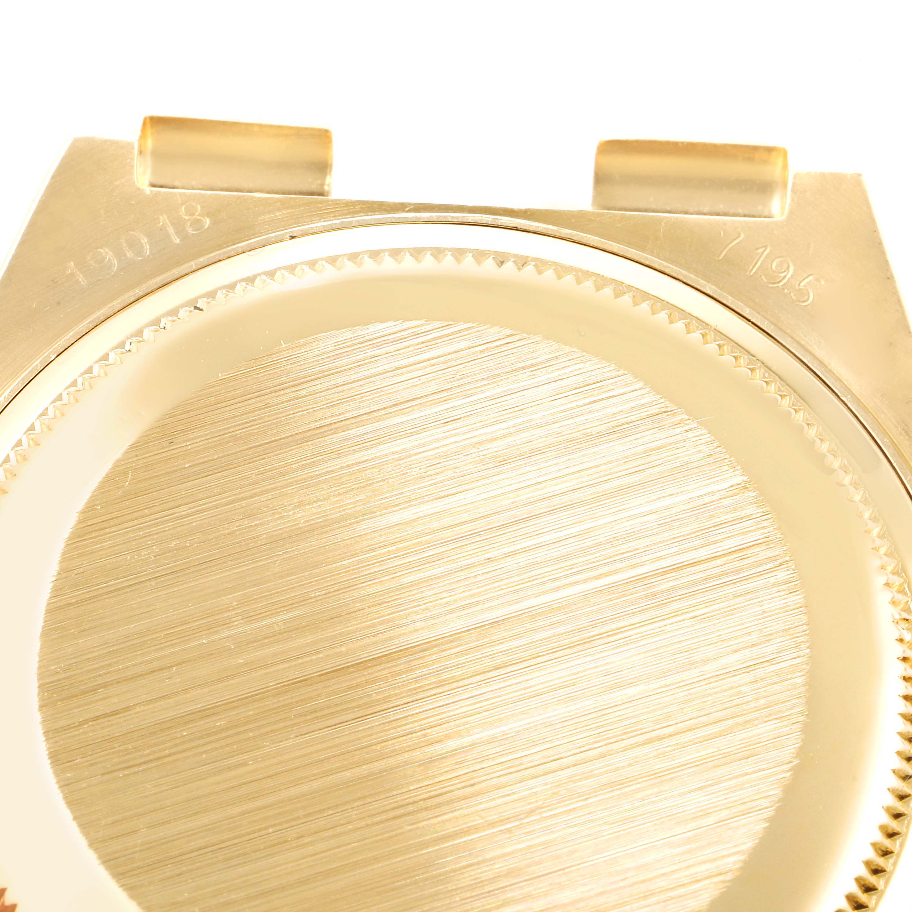 This image shows the back casing of a Rolex Oysterquartz 19018 Men's Yellow Gold Champagne Dial 19018 Men's Yellow Gold Champagne Dial watch from a top-down angle.
