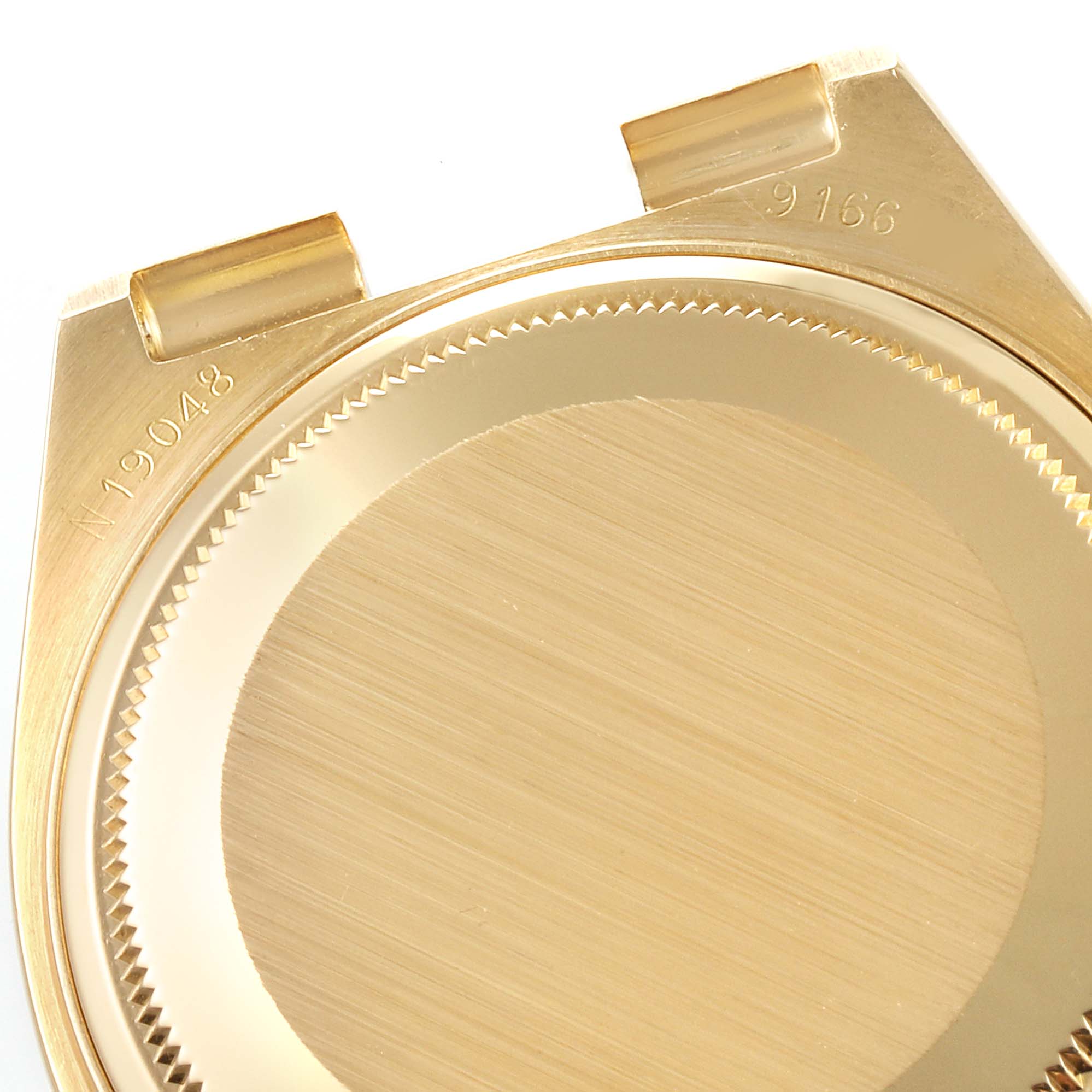 The image shows the back case and lugs of the Rolex Oysterquartz watch model in a gold tone, viewed from behind.