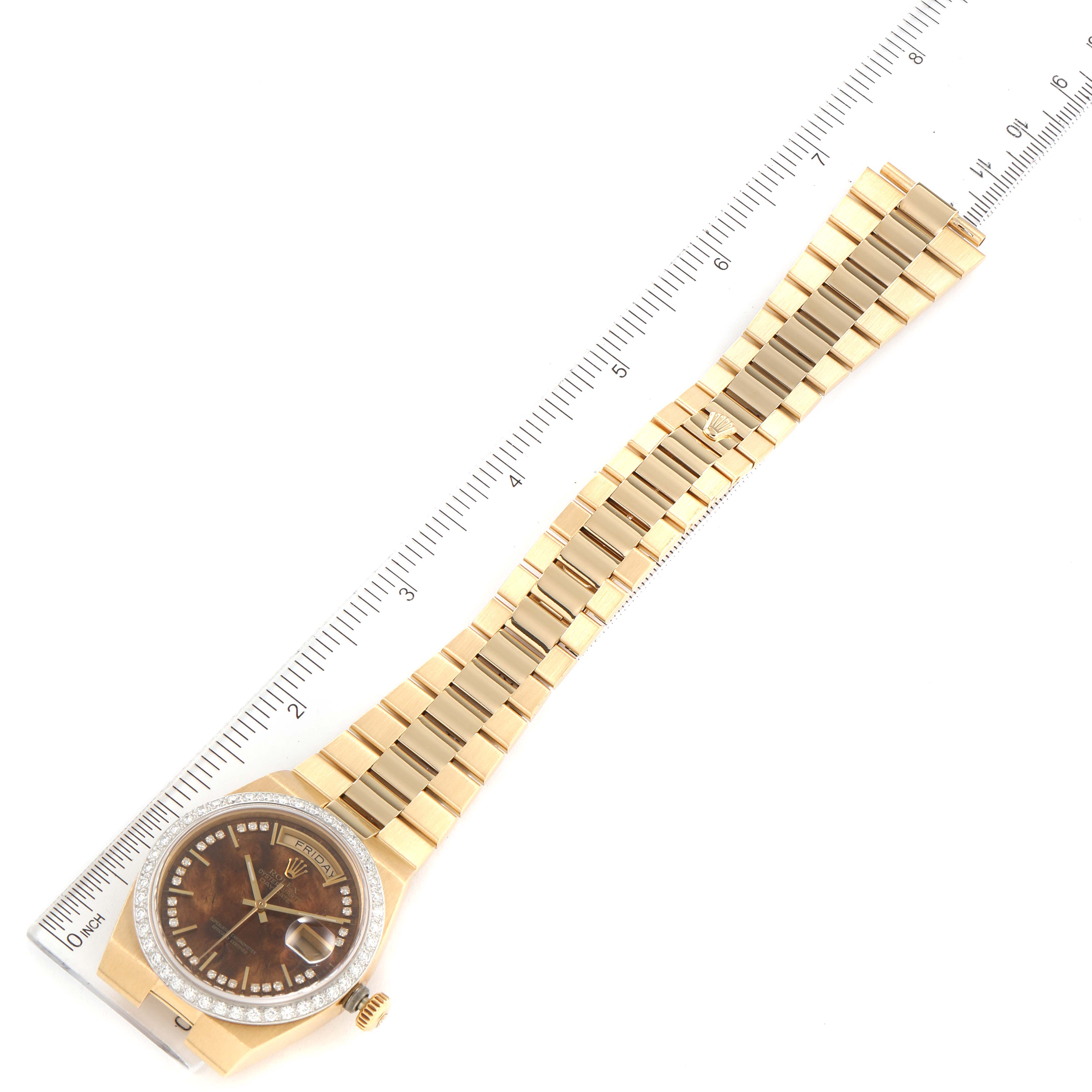The image shows a Rolex Oysterquartz watch viewed from above, displaying its case, dial, and entire bracelet alongside a ruler.