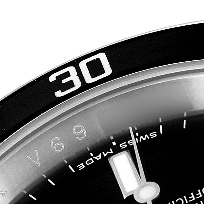 The image shows a close-up of the bezel, minute hand, and part of the dial of a Rolex Submariner 16610 Men
s Stainless Steel Black Dial 16610 Men
s Stainless Steel Black Dial watch.