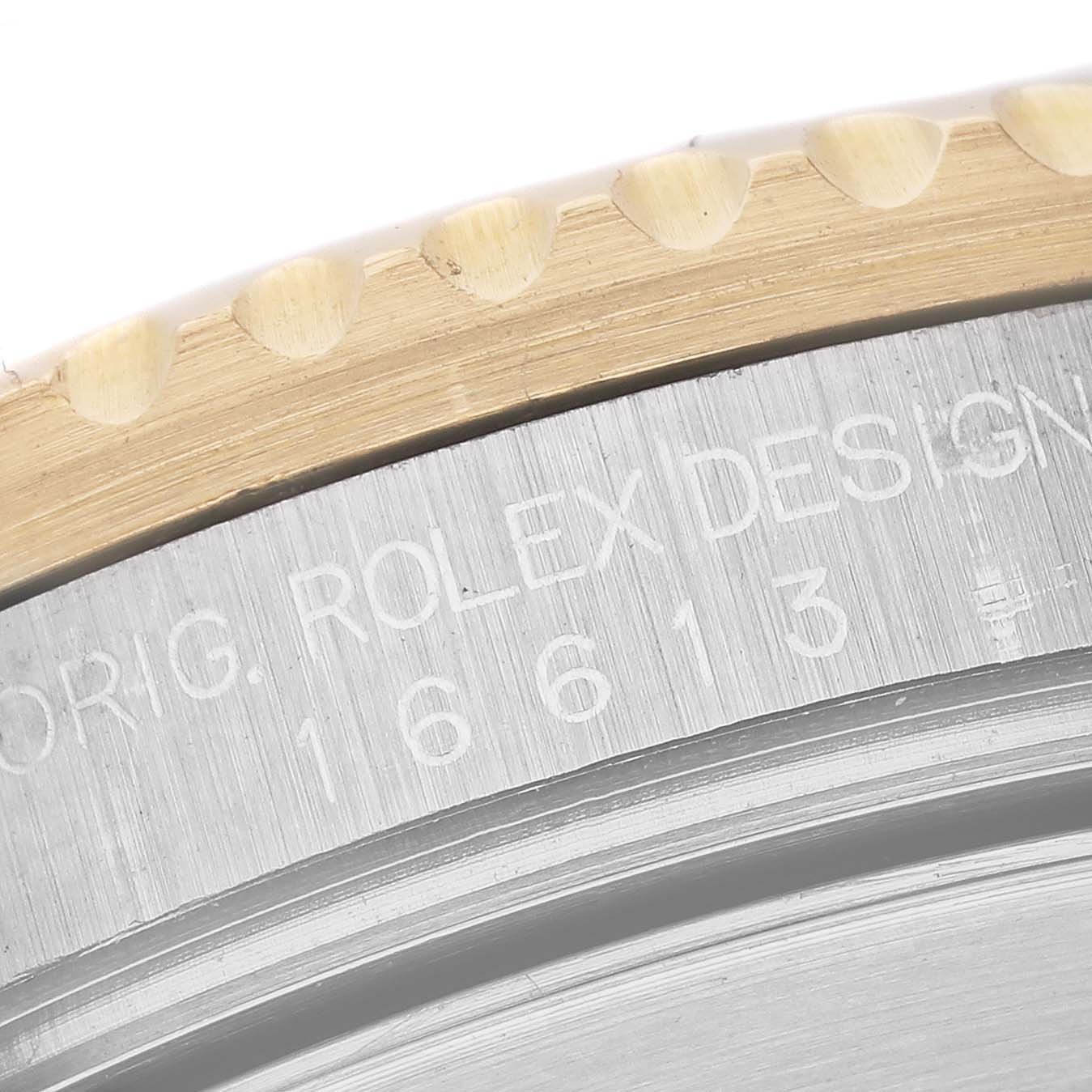 This close-up image shows the engraved bezel and case side of a Rolex Submariner 16613 Men's Steel and Gold (two tone) Blue Dial 16613 Men's Steel and Gold (two tone) Blue Dial, highlighting its design letters and model number "16613."