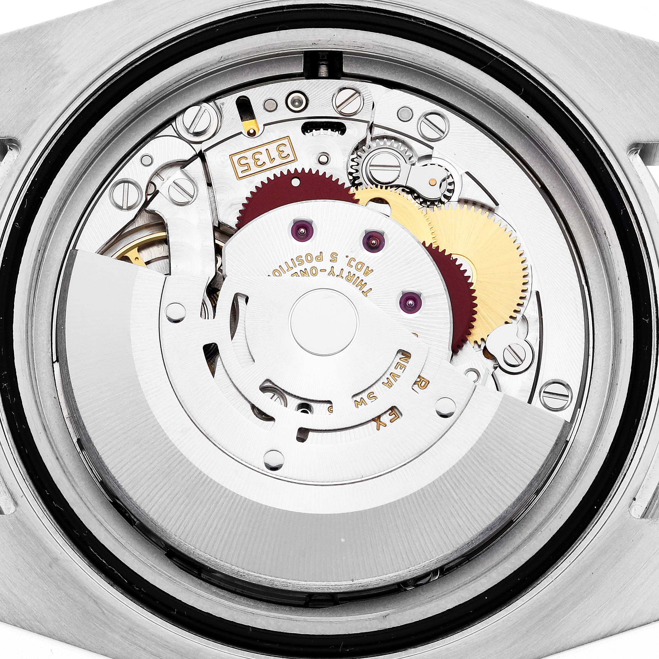 The image shows the movement of a Rolex Submariner 116610LN Men's Stainless Steel Black Dial 116610LN Men's Stainless Steel Black Dial watch from a rear angle, highlighting gears and components.