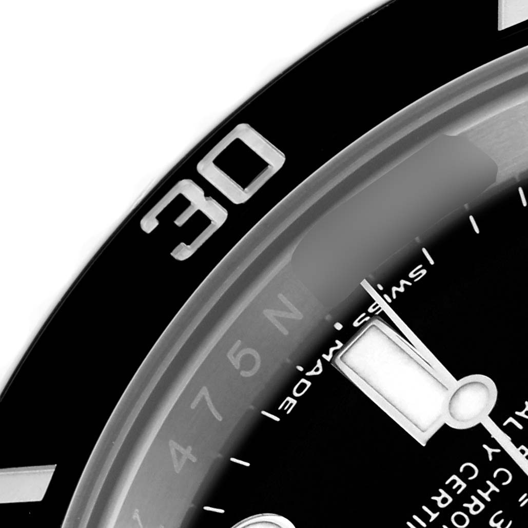 The image shows a close-up of the Rolex Submariner 116610LN Men's Stainless Steel Black Dial 116610LN Men's Stainless Steel Black Dial's bezel, part of the dial, and a watch hand.