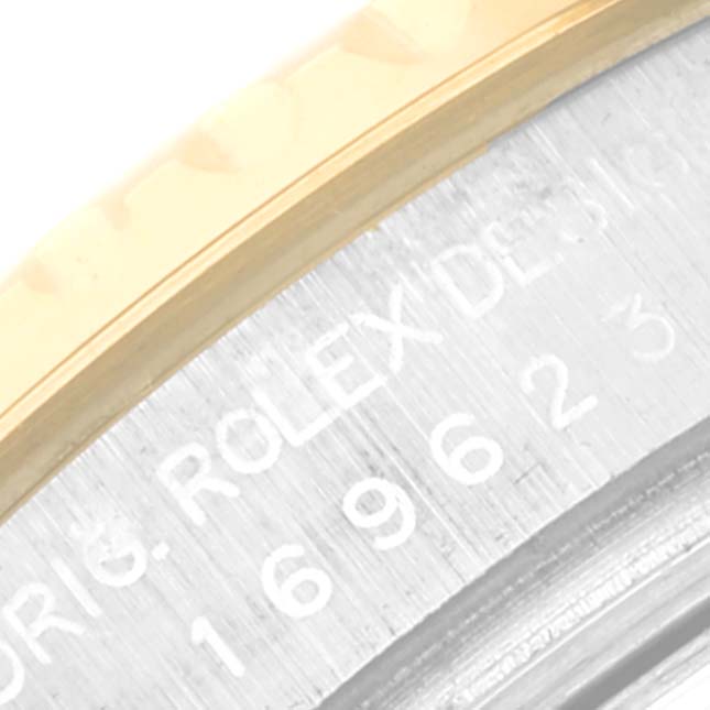 This is a close-up of the case and bezel of the Rolex Yacht-Master 169623 Women
s Steel and Gold (two tone) Silver Dial 169623 Women
s Steel and Gold (two tone) Silver Dial watch, showing part of the serial number and the "ORIG. ROLEX DESIGN" engraving.