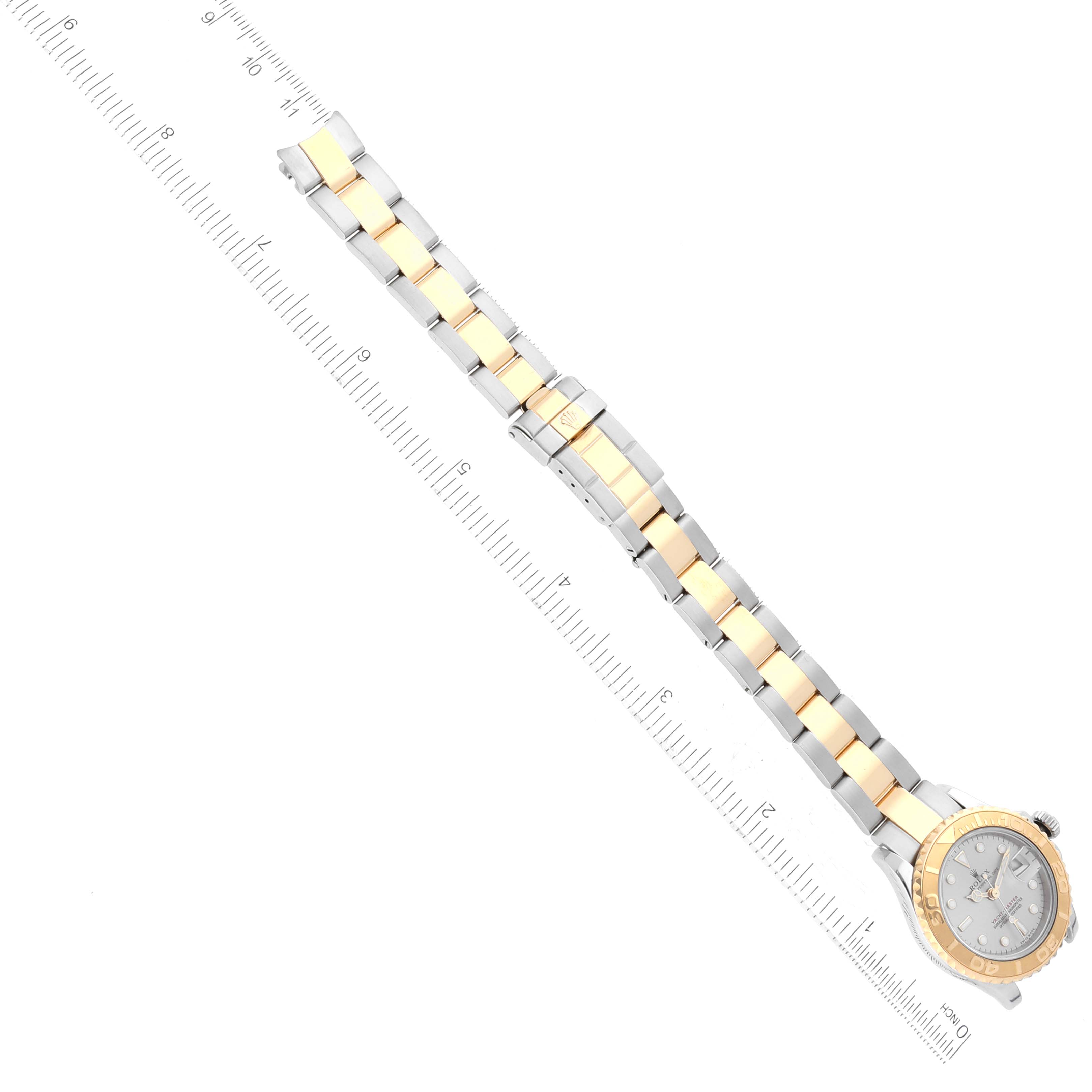 The image shows a Rolex Yacht-Master 169623 Women
s Steel and Gold (two tone) Silver Dial 169623 Women
s Steel and Gold (two tone) Silver Dial watch from a top-down angle, highlighting its dial, bezel, and bracelet.