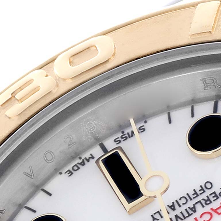 This image shows a close-up of the Rolex Yacht-Master 169623 Women's Steel and Gold (two tone) White Dial 169623 Women's Steel and Gold (two tone) White Dial watch, highlighting the bezel, part of the dial, and minute markers.