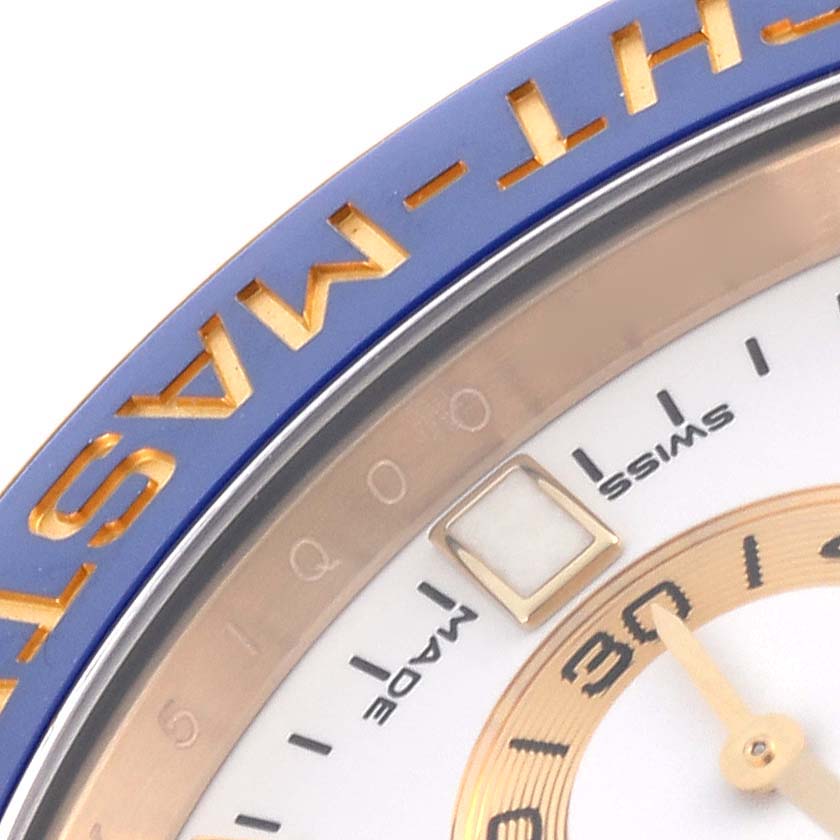 The image shows a close-up of the Rolex Yacht-Master 116688 Men's Yellow Gold White Dial 116688 Men's Yellow Gold White Dial's bezel, dial, and part of the minute hand.
