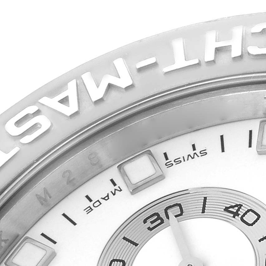 This close-up image shows part of the bezel and face of a Rolex Yacht-Master 116689 Men's White Gold White Dial 116689 Men's White Gold White Dial watch, highlighting the text and minute markers.
