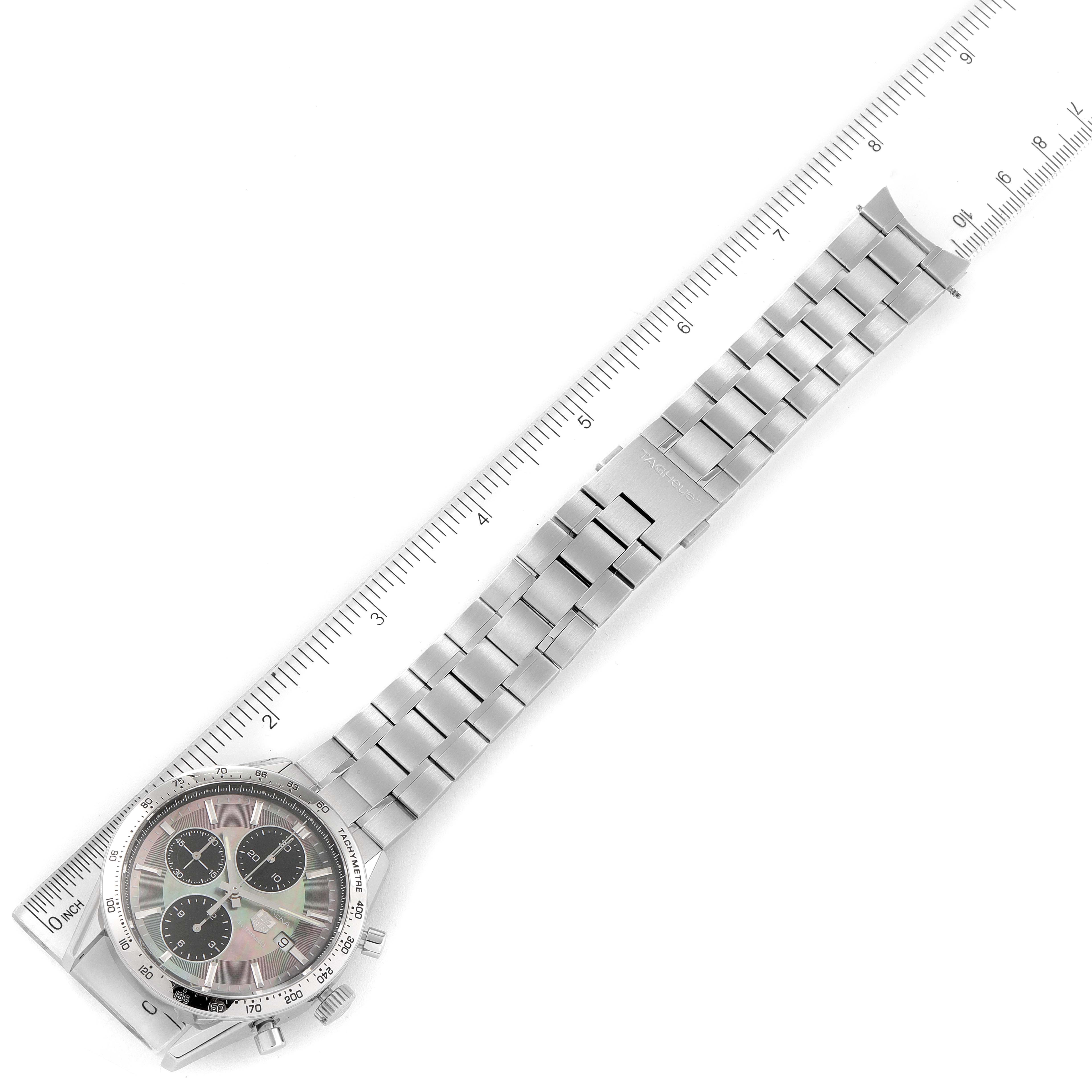 The image shows a top view of a Tag Heuer Carrera CV201P Men's Stainless Steel Mother of Pearl Dial CV201P Men's Stainless Steel Mother of Pearl Dial watch, displaying the watch face and metal bracelet next to a ruler.