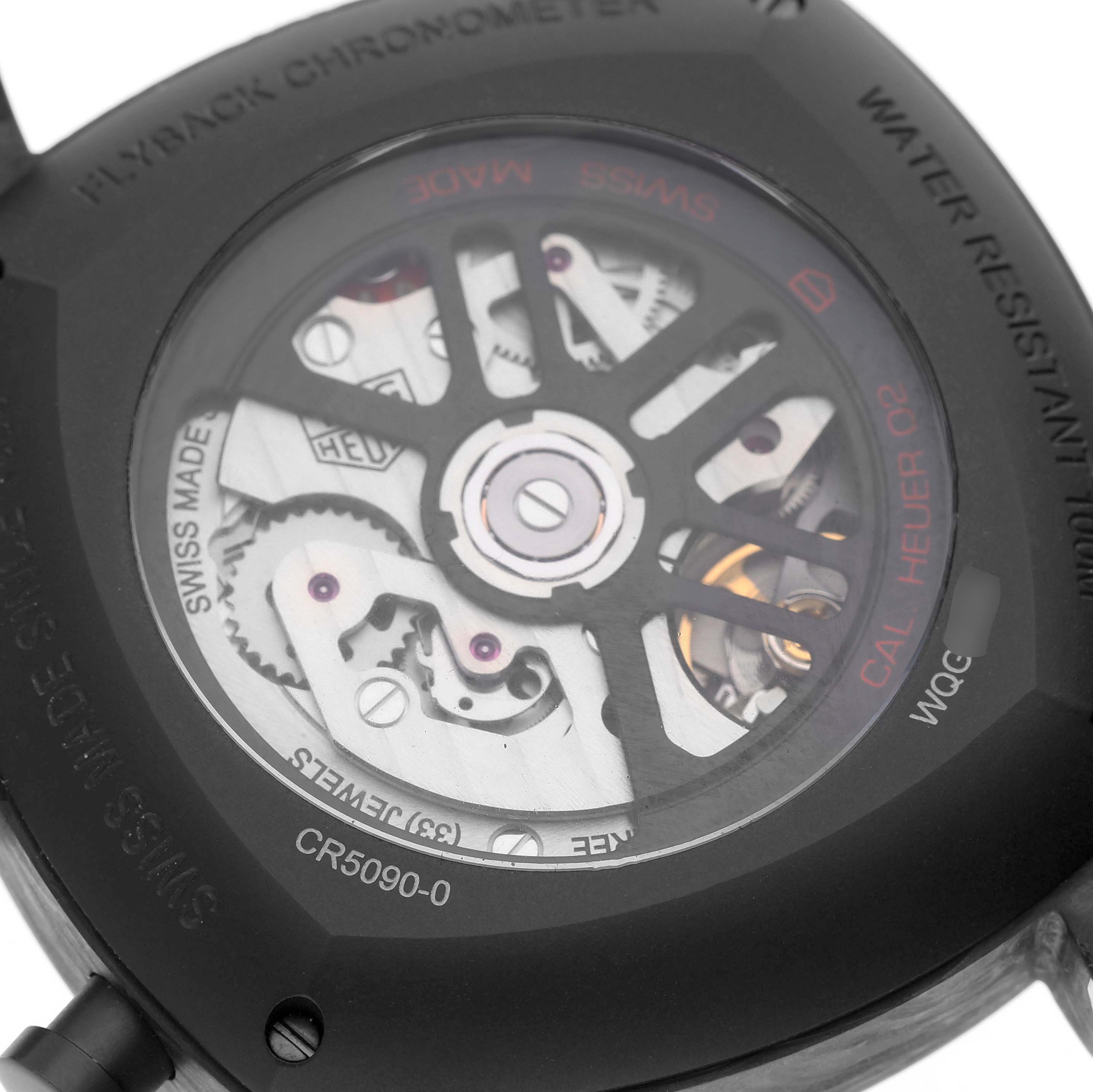 The image shows the back of the Tag Heuer Monza CR5090.FN6001 Men's Titanium Grey Dial watch, highlighting its exposed movement and intricate mechanics.