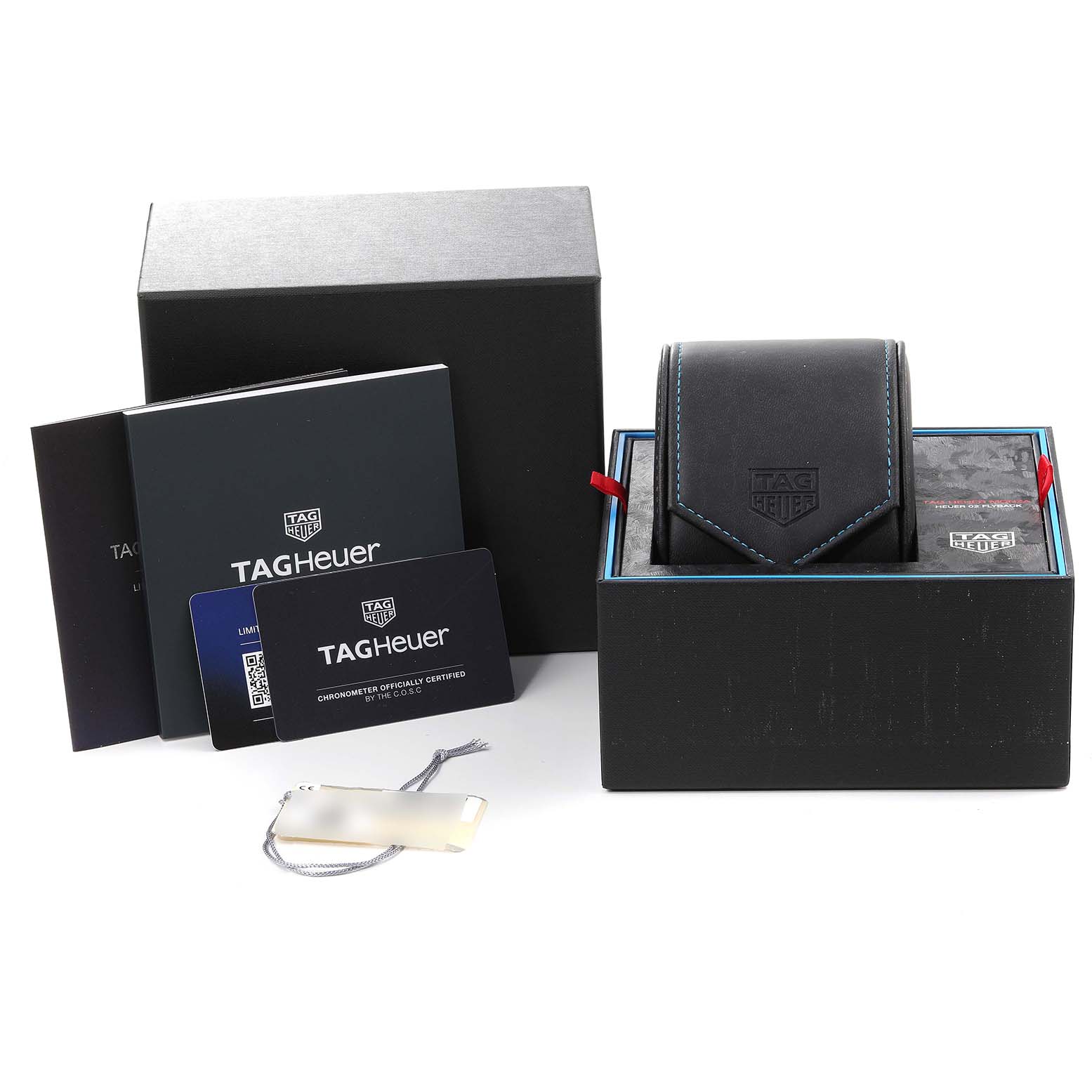 This image shows the Tag Heuer Monza CR5090.FN6001 Men
s Titanium Grey Dial CR5090.FN6001 Men
s Titanium Grey Dial watch box, manuals, warranty cards, and a tag, viewed from the front.