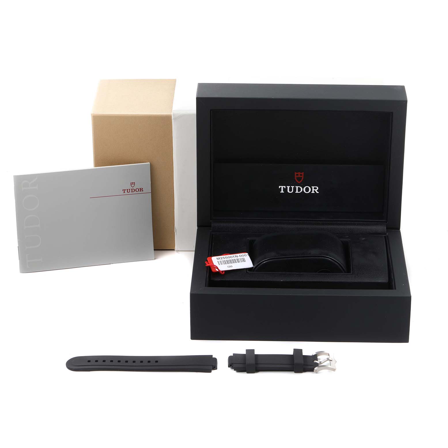 The image shows the Tudor Pelagos 25500TN Men's Platinum Black Dial 25500TN Men's Platinum Black Dial watch packaging including the box, a booklet, an extra rubber strap, and tags.