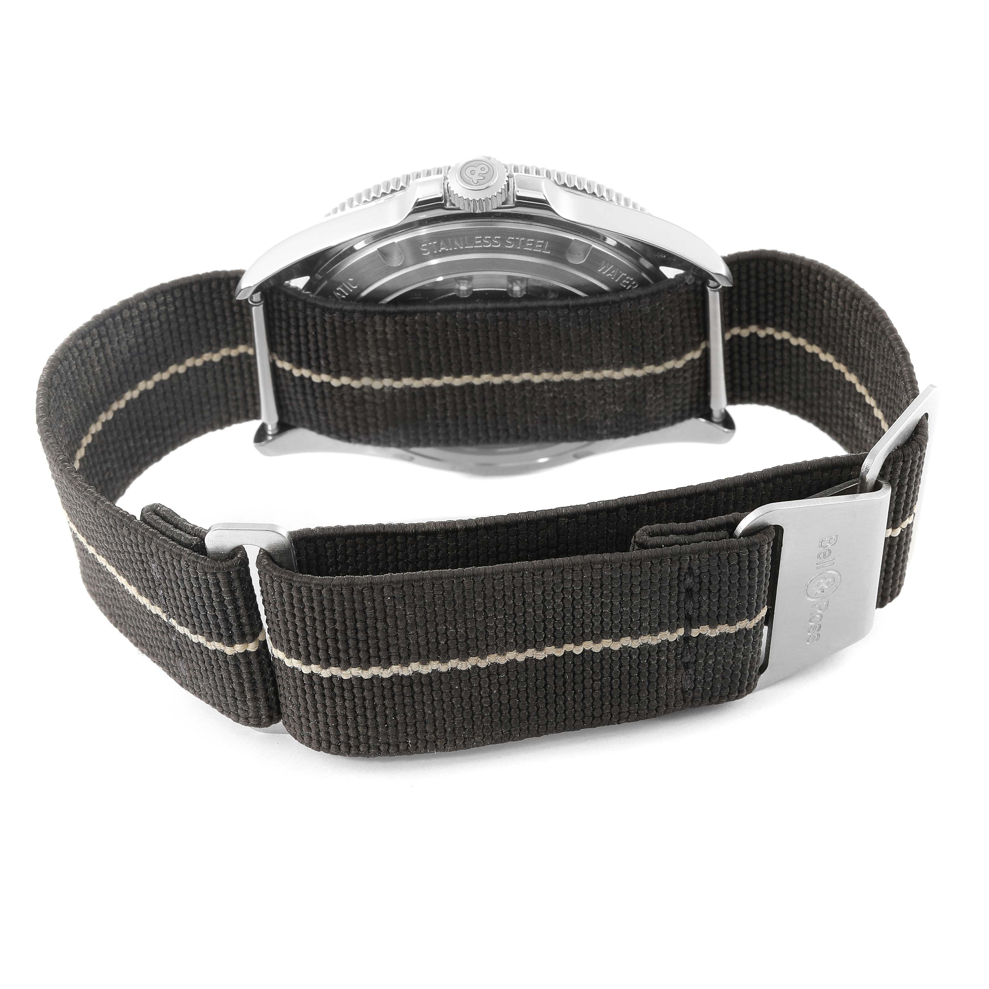 The image shows the back of a Bell 
Ross Heritage BRV2-92-S-03618 Men
s Stainless Steel Beige Dial BRV2-92-S-03618 Men
s Stainless Steel Beige Dial model watch, highlighting the stainless steel case and fabric strap with a buckle.