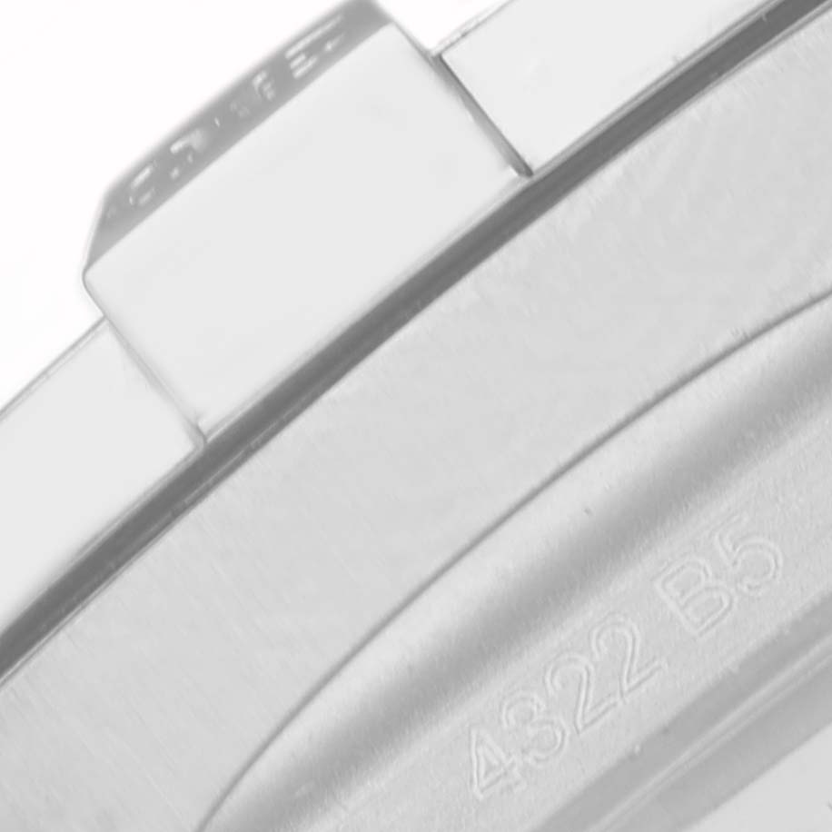 The image shows a close-up of the bezel and side case of a Breitling Chronomat A32397 Men
s Stainless Steel White Dial A32397 Men
s Stainless Steel White Dial watch, including part of the model number engraving.