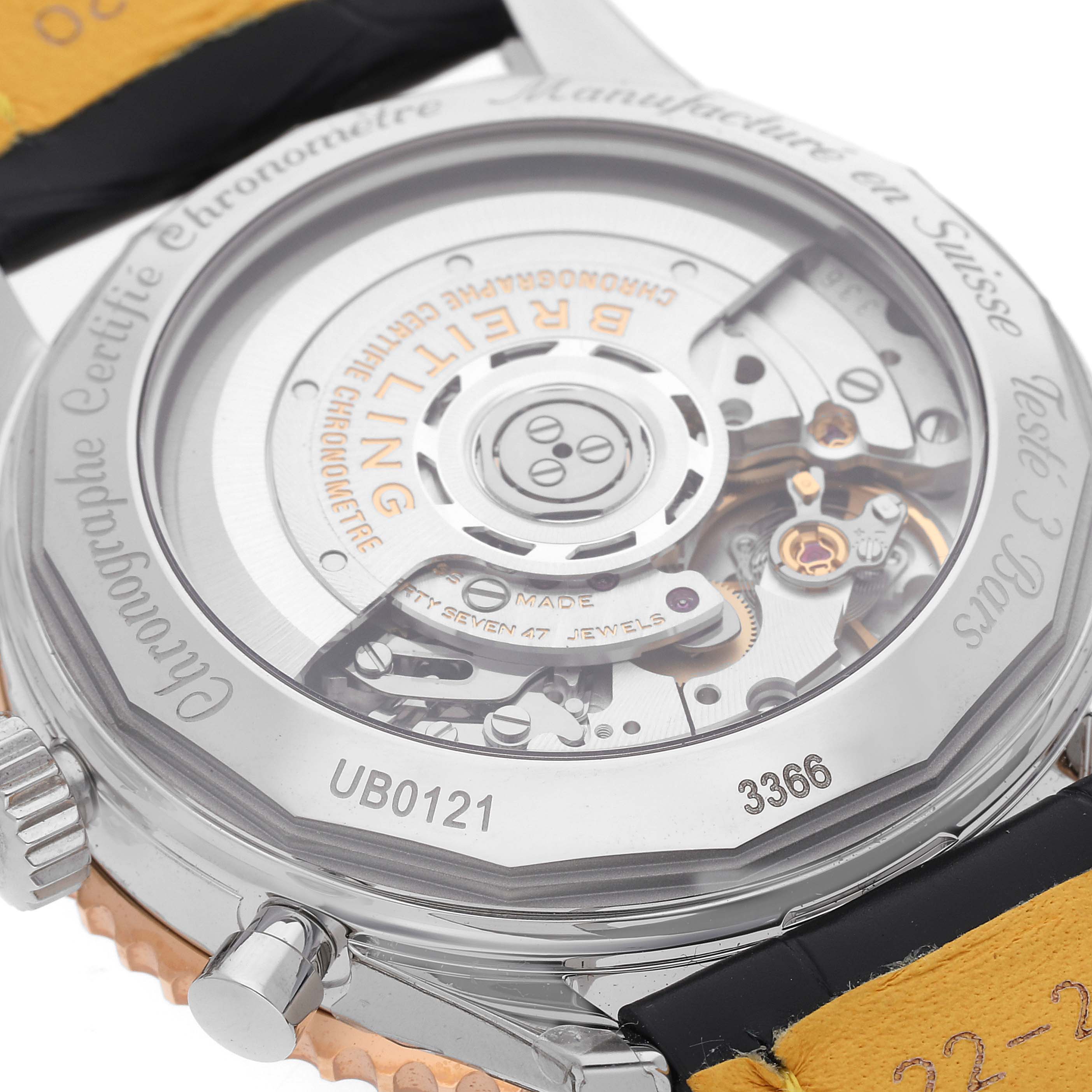The image shows the back view of a Breitling Navitimer UB0121 Men's Steel and Gold (two tone) Grey Dial UB0121 Men's Steel and Gold (two tone) Grey Dial watch, highlighting its automatic movement and intricate inner workings.