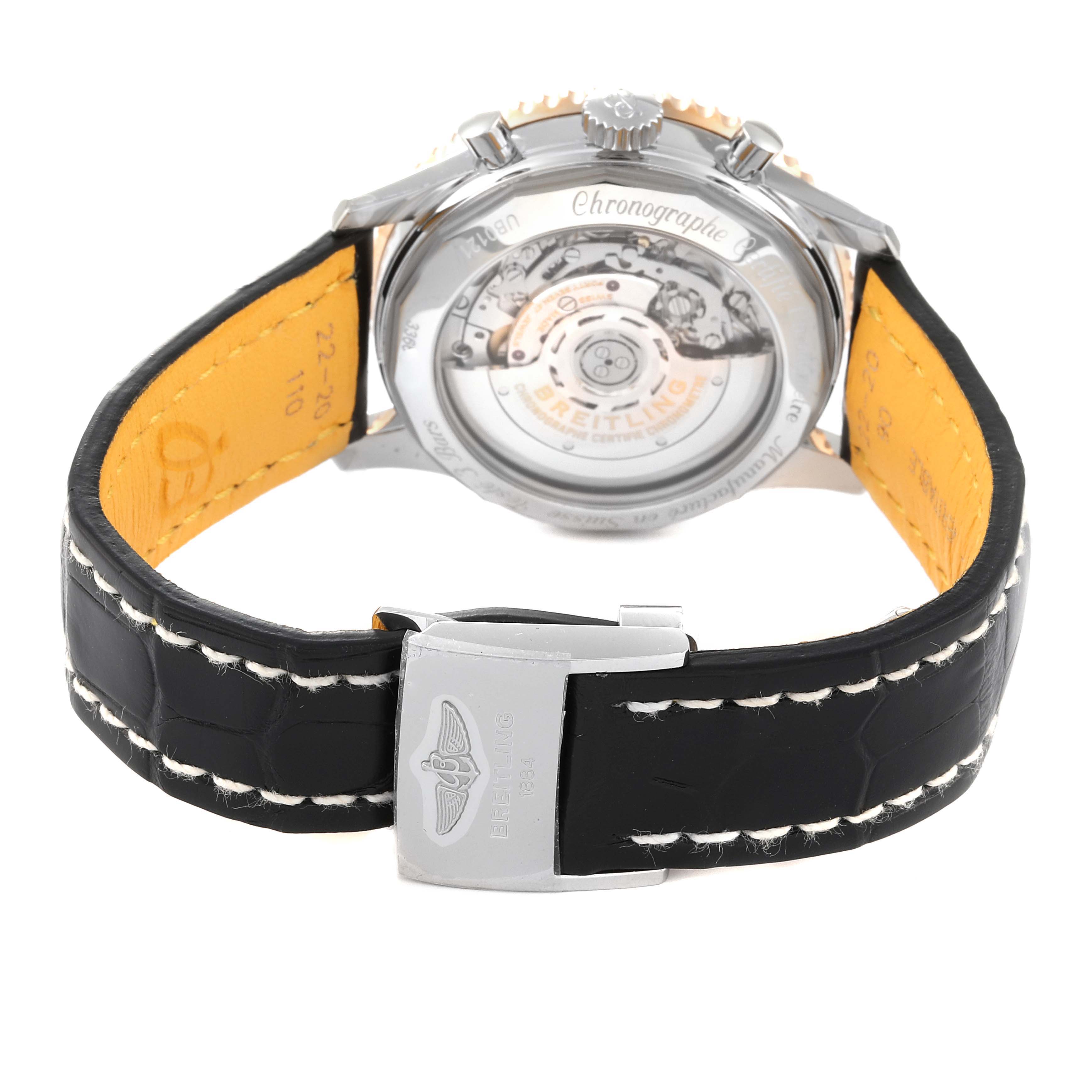 The image shows the back view of a Breitling Navitimer UB0121 Men's Steel and Gold (two tone) Grey Dial UB0121 Men's Steel and Gold (two tone) Grey Dial watch, displaying the movement and clasp on a leather strap.