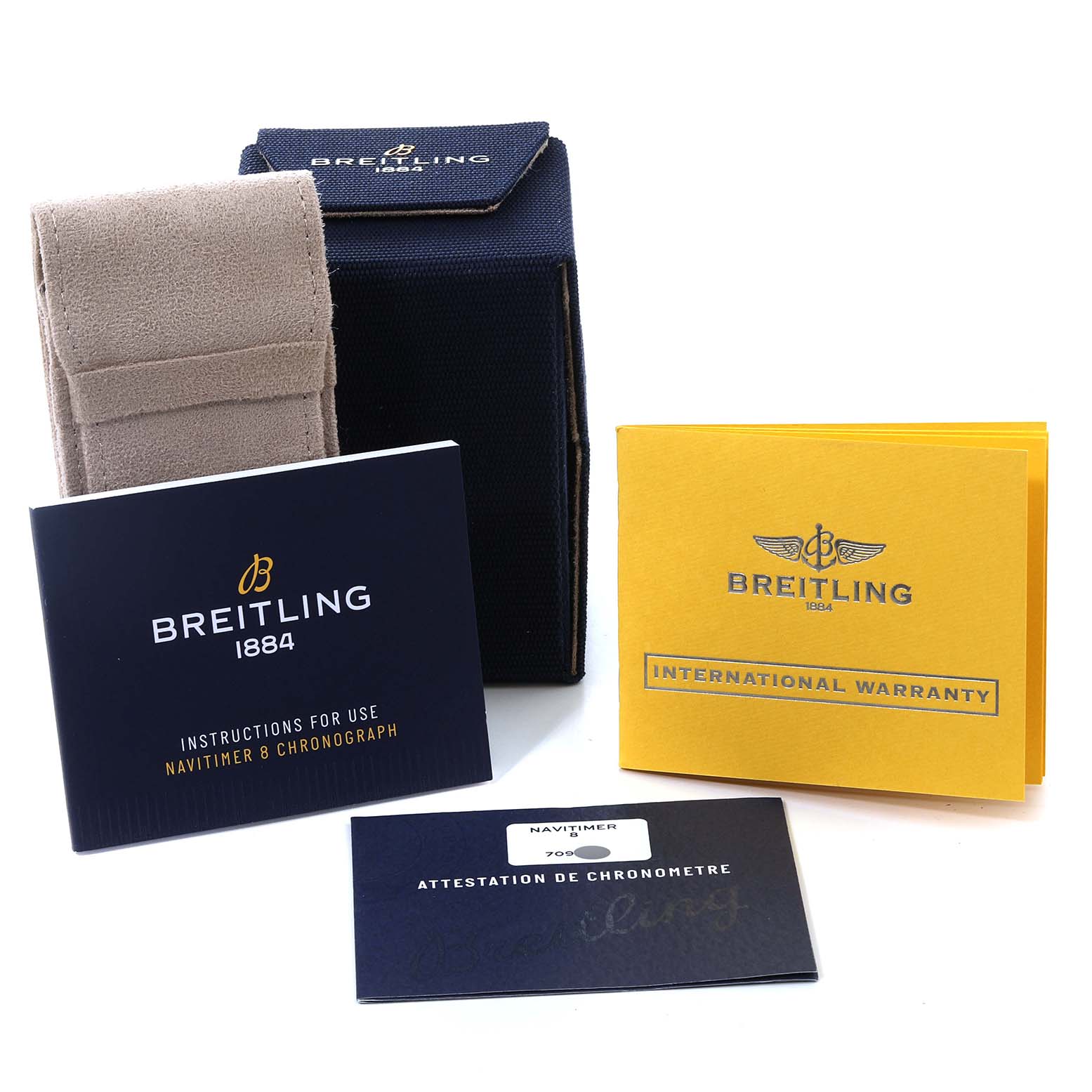 This image shows the packaging, instruction booklet, international warranty card, and chronometer certificate for a Breitling Navitimer M13314 Men's Stainless Steel Black Dial M13314 Men's Stainless Steel Black Dial watch.