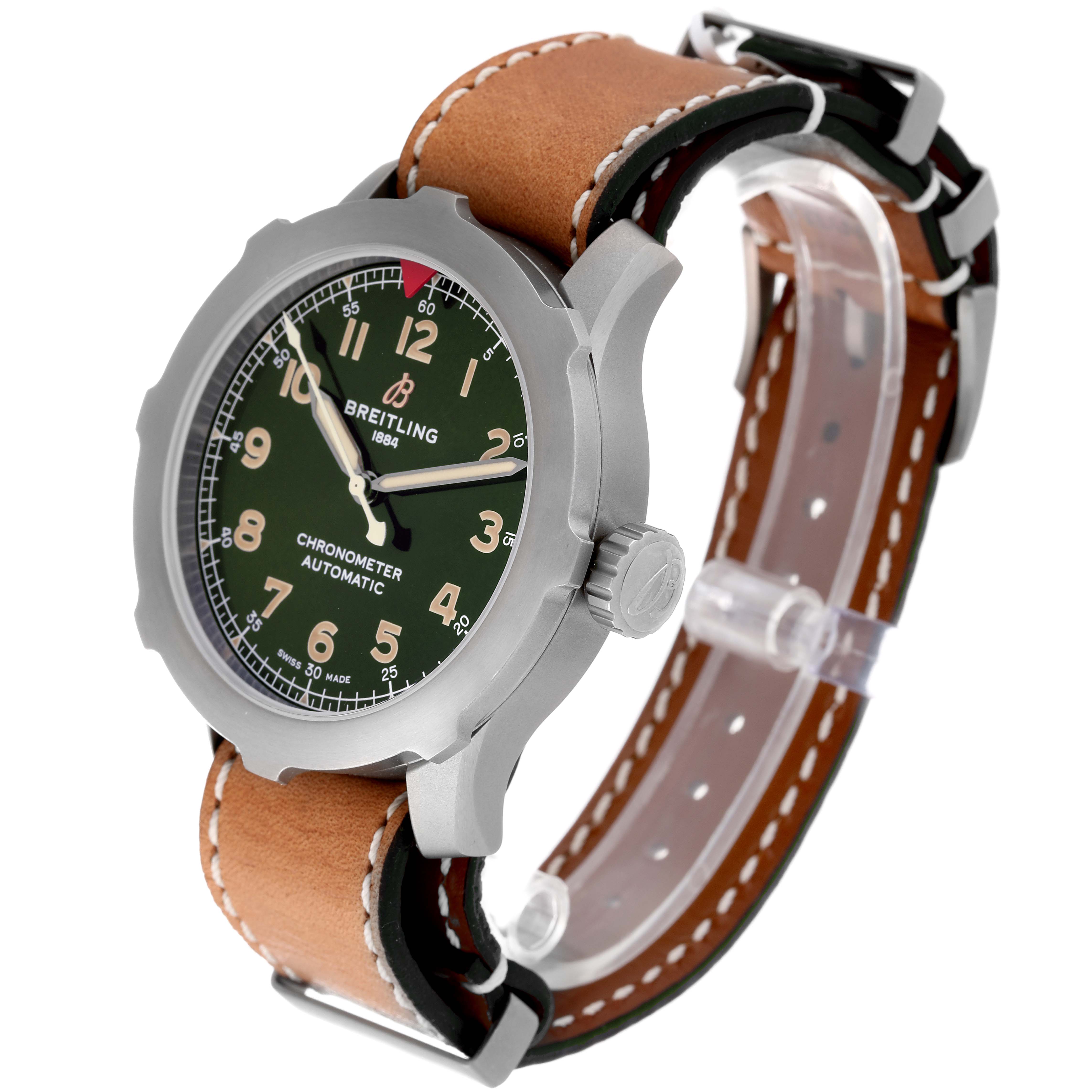 The Breitling Navitimer watch is shown at an angle displaying the watch face, crown, and brown leather strap.