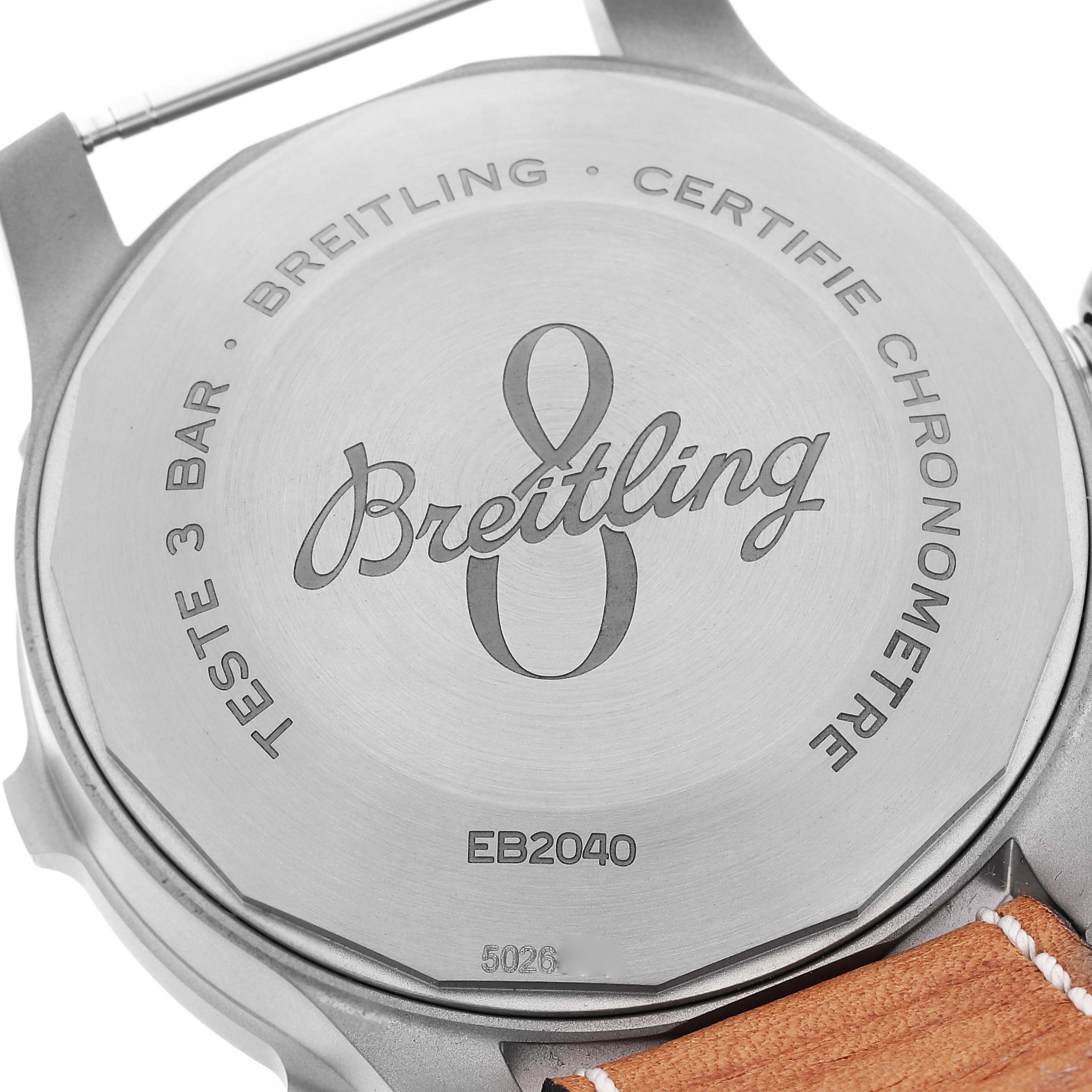 The image shows the back case and part of the leather strap of a Breitling Navitimer watch.