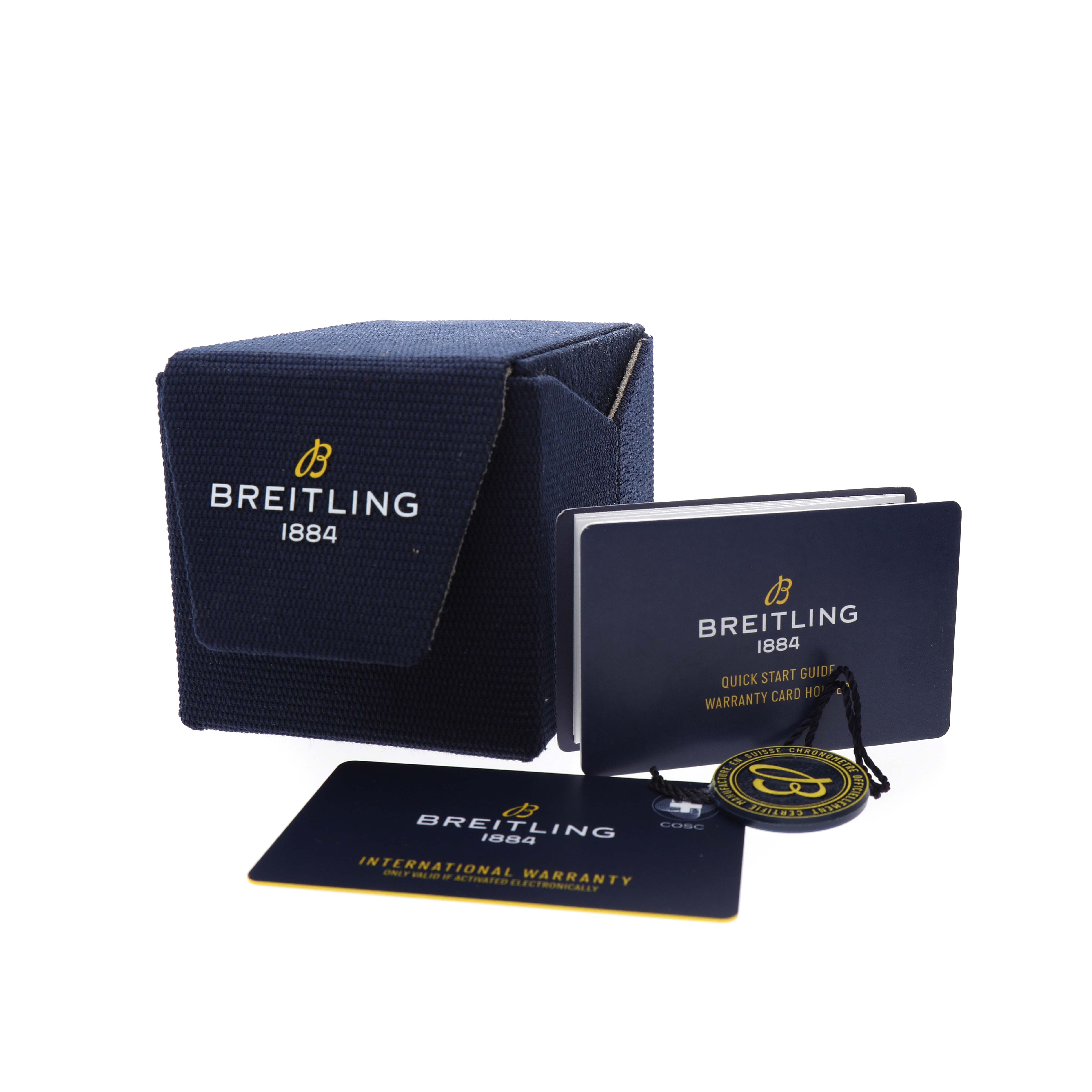 The image shows the packaging and accessories for a Breitling Superocean AB3111 Men's Stainless Steel Green Dial watch, including a box, manuals, and a warranty card.
