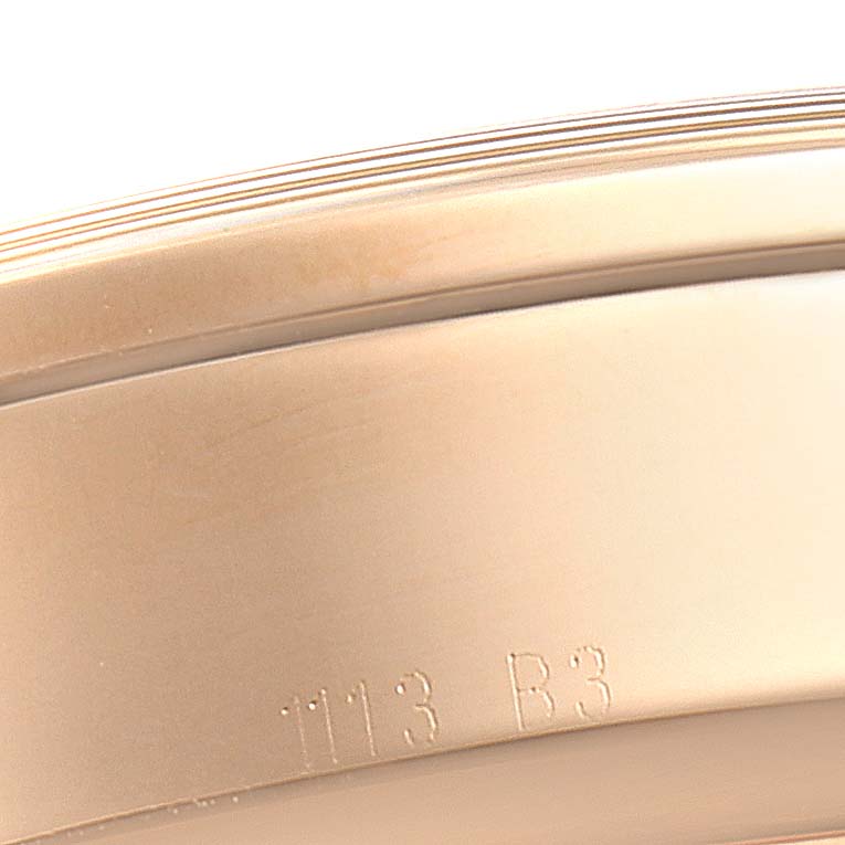 This close-up image shows the side case of the Breitling Transocean RB0510 Men's Rose Gold Blue Dial RB0510 Men's Rose Gold Blue Dial watch with engraved markings.