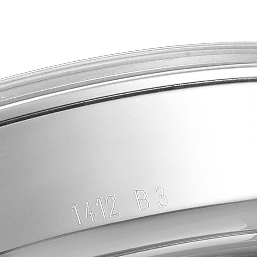 This image shows a close-up view of the bezel and a portion of the case back of a Breitling Transocean AB0510 Men's Stainless Steel Silver Dial AB0510 Men's Stainless Steel Silver Dial watch, featuring engraved details.