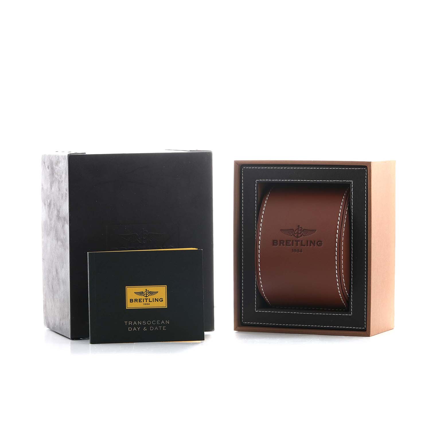 The image shows a Breitling Transocean A45310 Men's Stainless Steel Silver Dial packaging with a black box, a branded booklet, and a brown watch case.