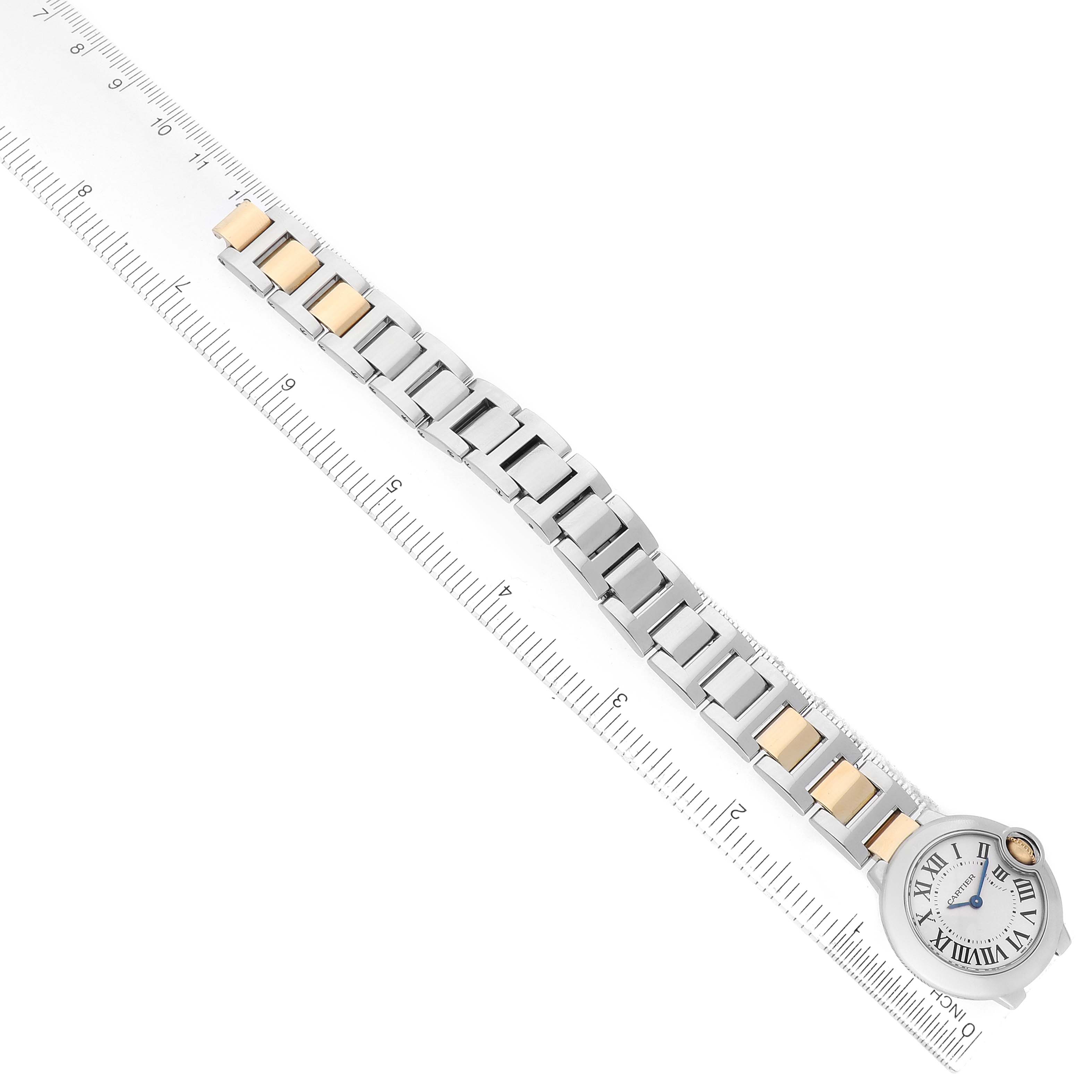 The Cartier Ballon Bleu W69007Z3 Women's Steel and Gold (two tone) Silver Dial watch is shown from above, featuring the full band and face alongside a ruler for scale.