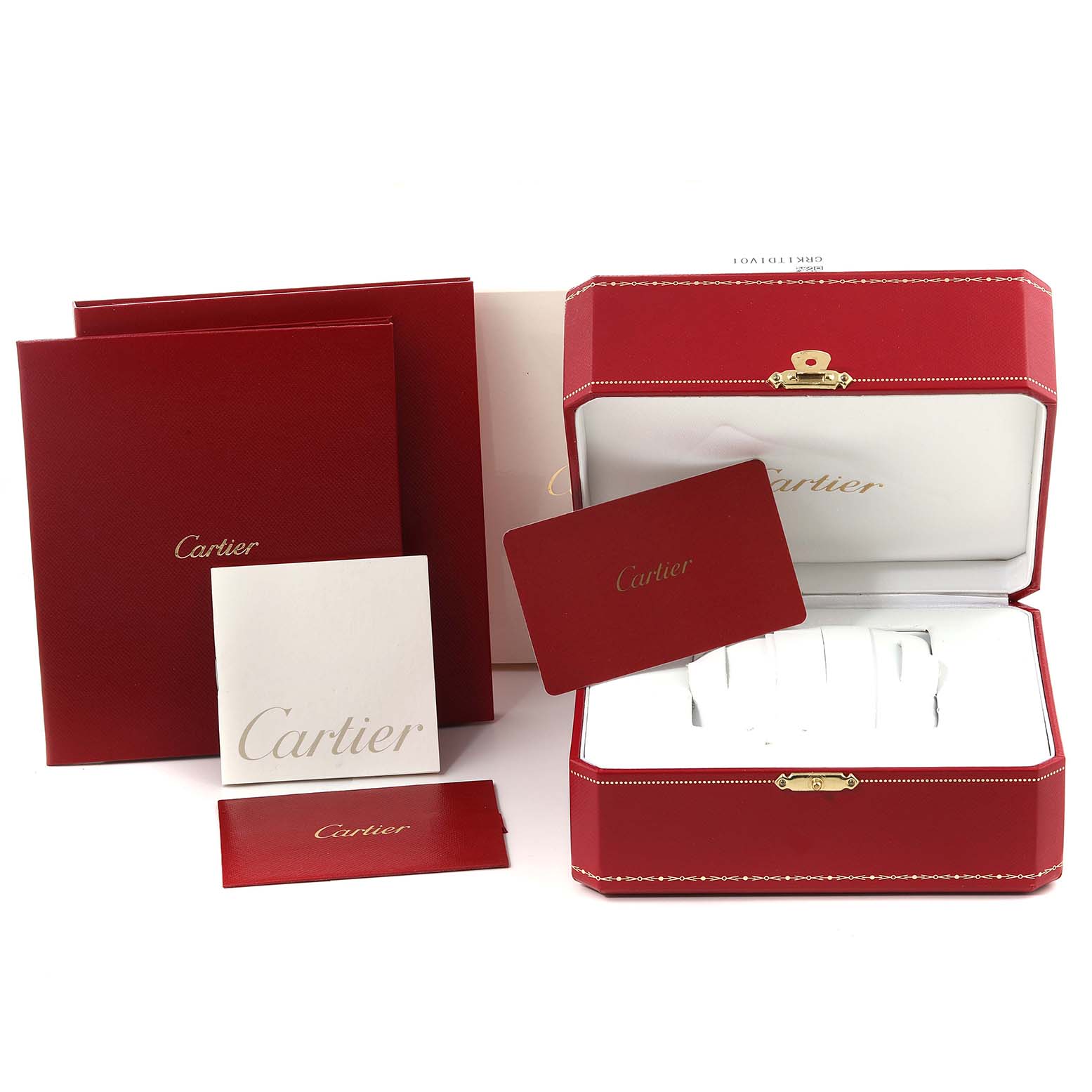 This image shows the packaging and accessories for the Calibre de Cartier watch by Cartier, including the box, manuals, and warranty cards.
