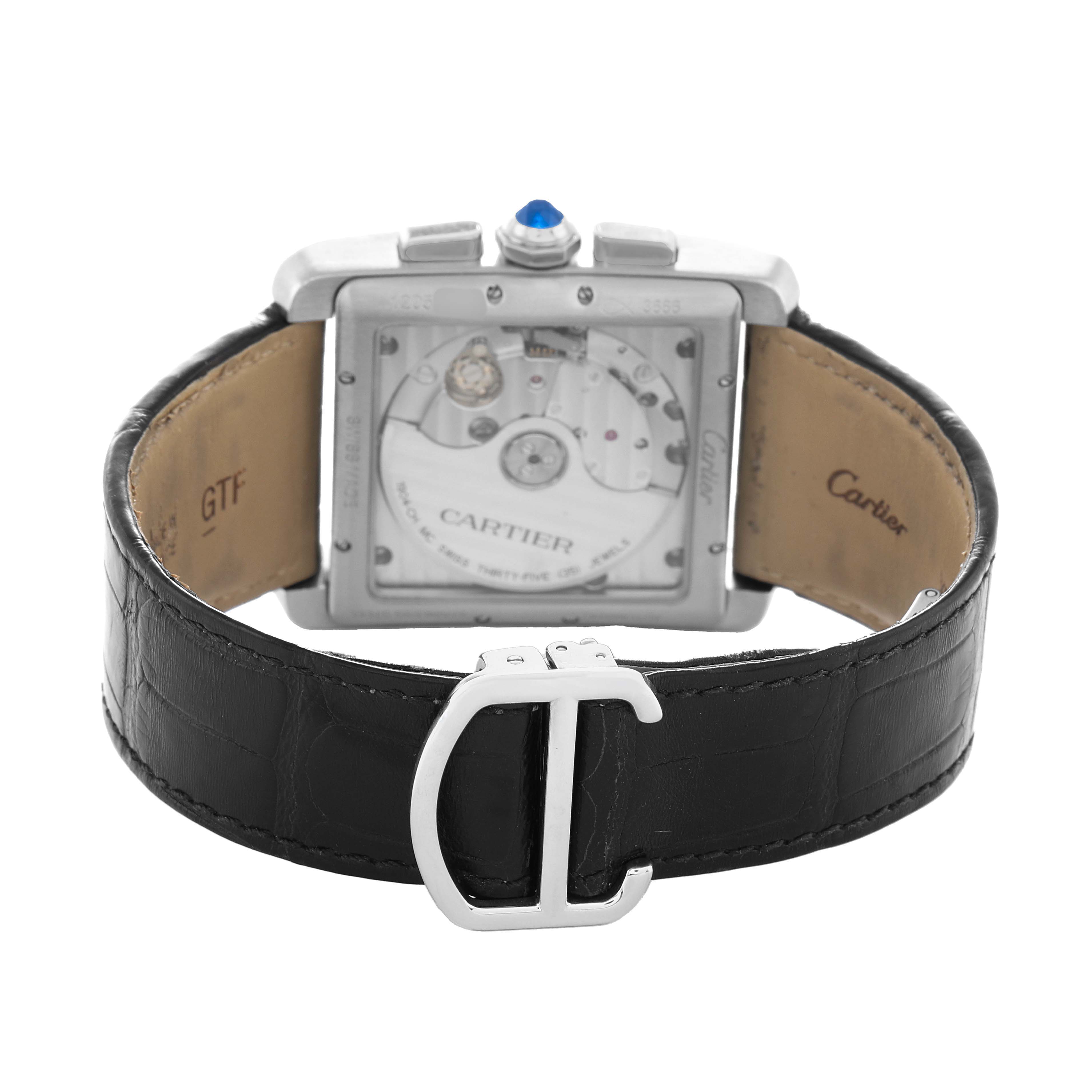 The image shows the back view of a Cartier Tank MC W5330007 Men's Stainless Steel Silver Dial watch, displaying its movement and leather strap with a clasp.