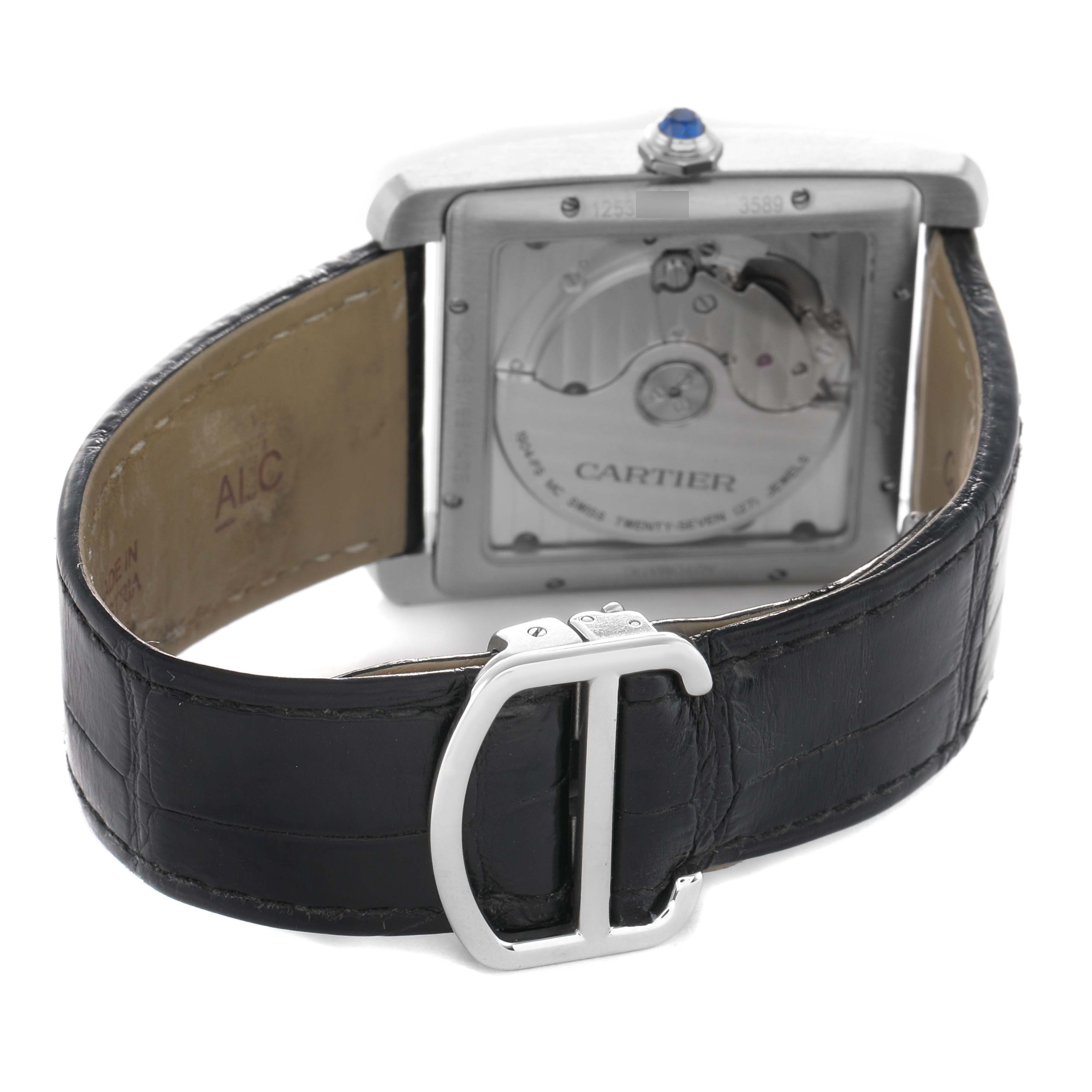 The Cartier Tank MC W5330004 Men's Stainless Steel Black Dial watch is shown from a rear angle displaying its movement and part of the leather strap with a buckle.