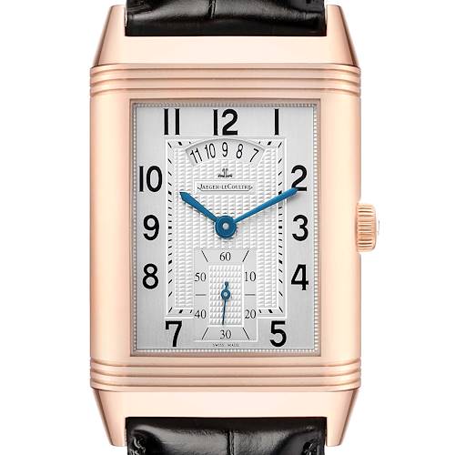 The Jaeger-LeCoultre Reverso watch is shown from the front, highlighting its rectangular face and blue hands.