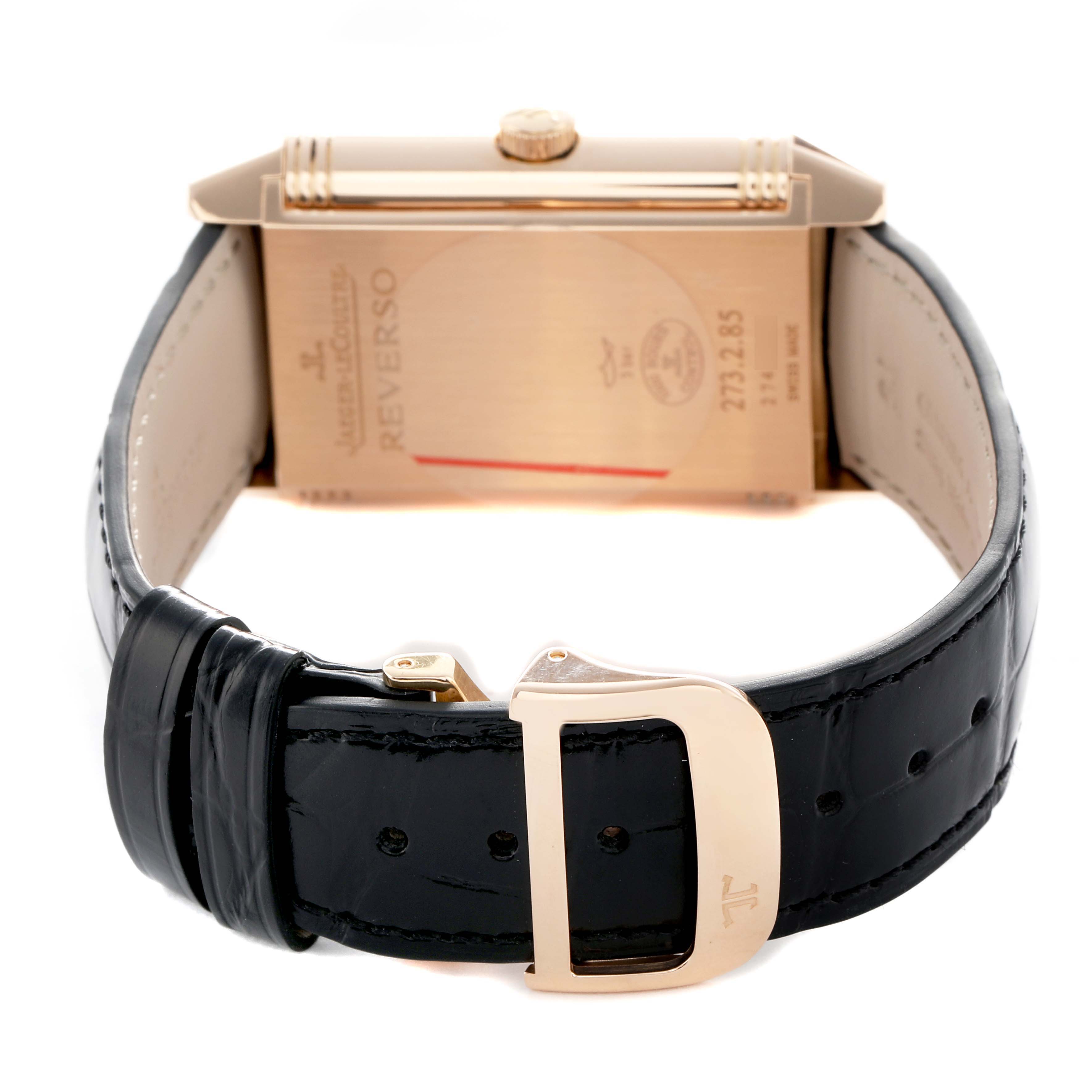 The Jaeger-LeCoultre Reverso watch is shown from the side, highlighting the back case and the buckle on the leather strap.