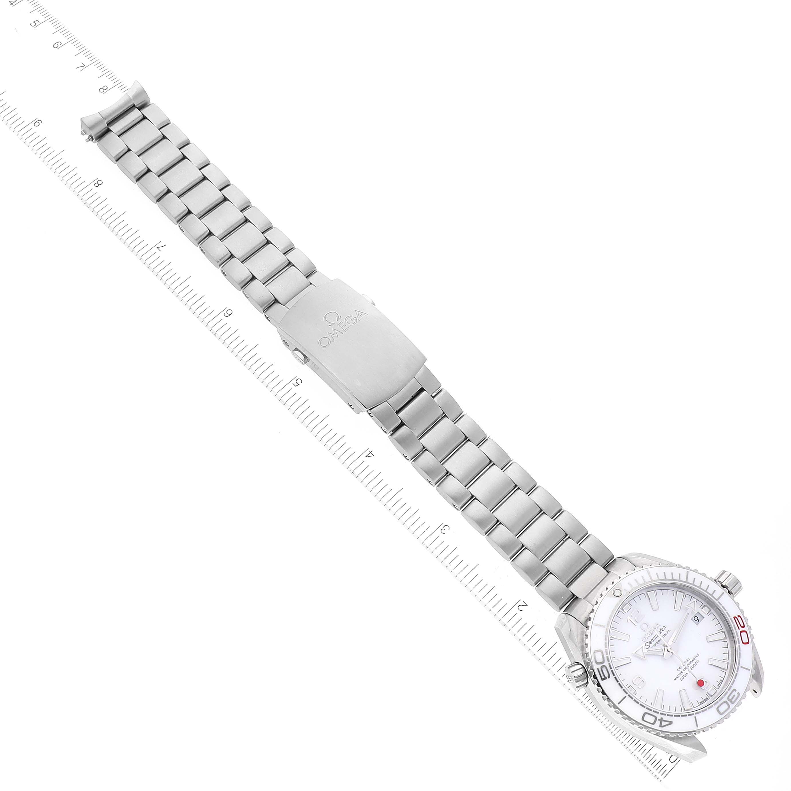 The Omega Planet Ocean 522.33.40.20.04.001 Men's Stainless Steel White Dial 522.33.40.20.04.001 Men's Stainless Steel White Dial watch is shown from the top view, detailing the watch face, bracelet, and clasp alongside a ruler for measurement.