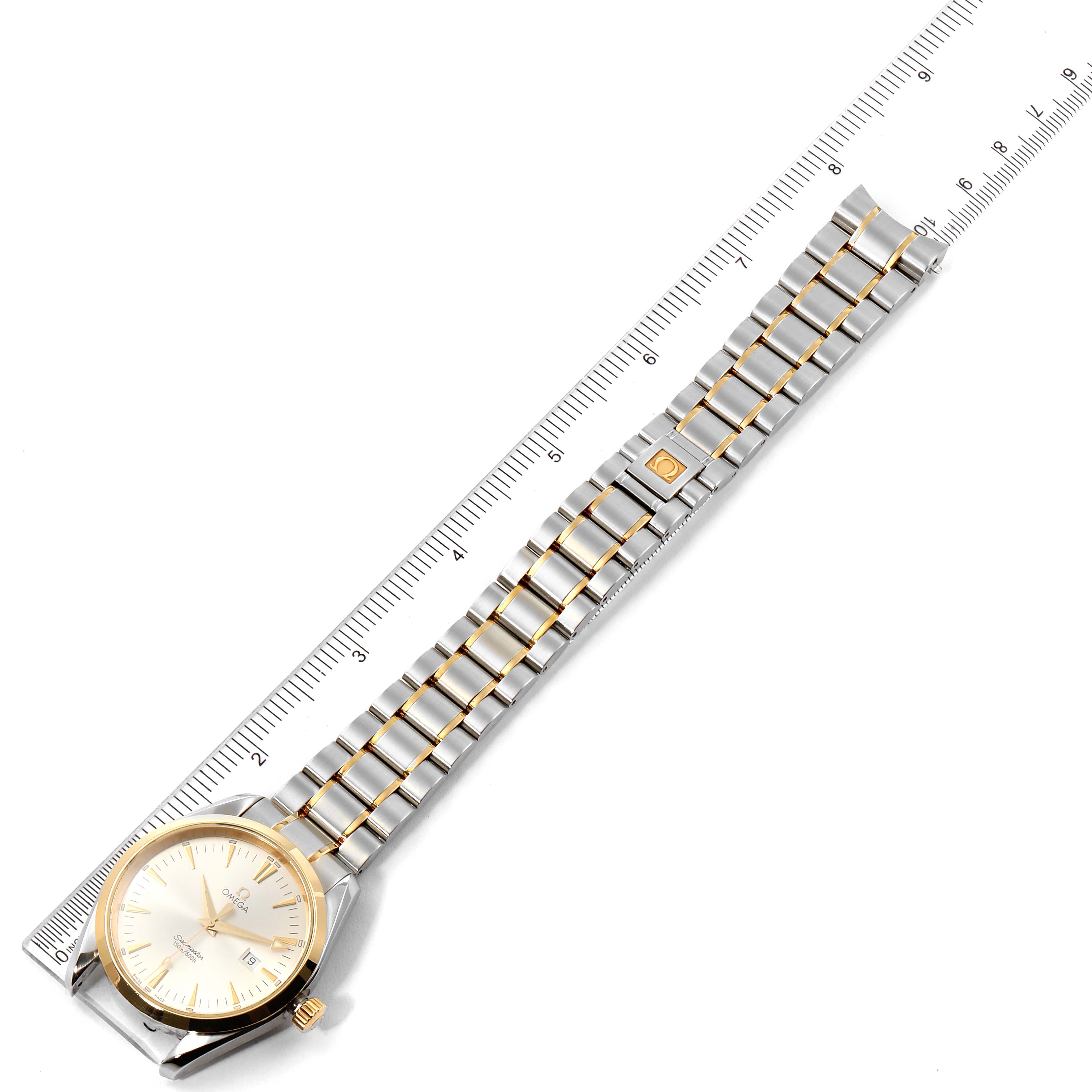 The Omega Aqua Terra 2317.30.00 Men's Steel and Gold (two tone) Silver Dial 2317.30.00 Men's Steel and Gold (two tone) Silver Dial watch is photographed from a top-down angle, showing the face, band, and crown next to a ruler for scale.