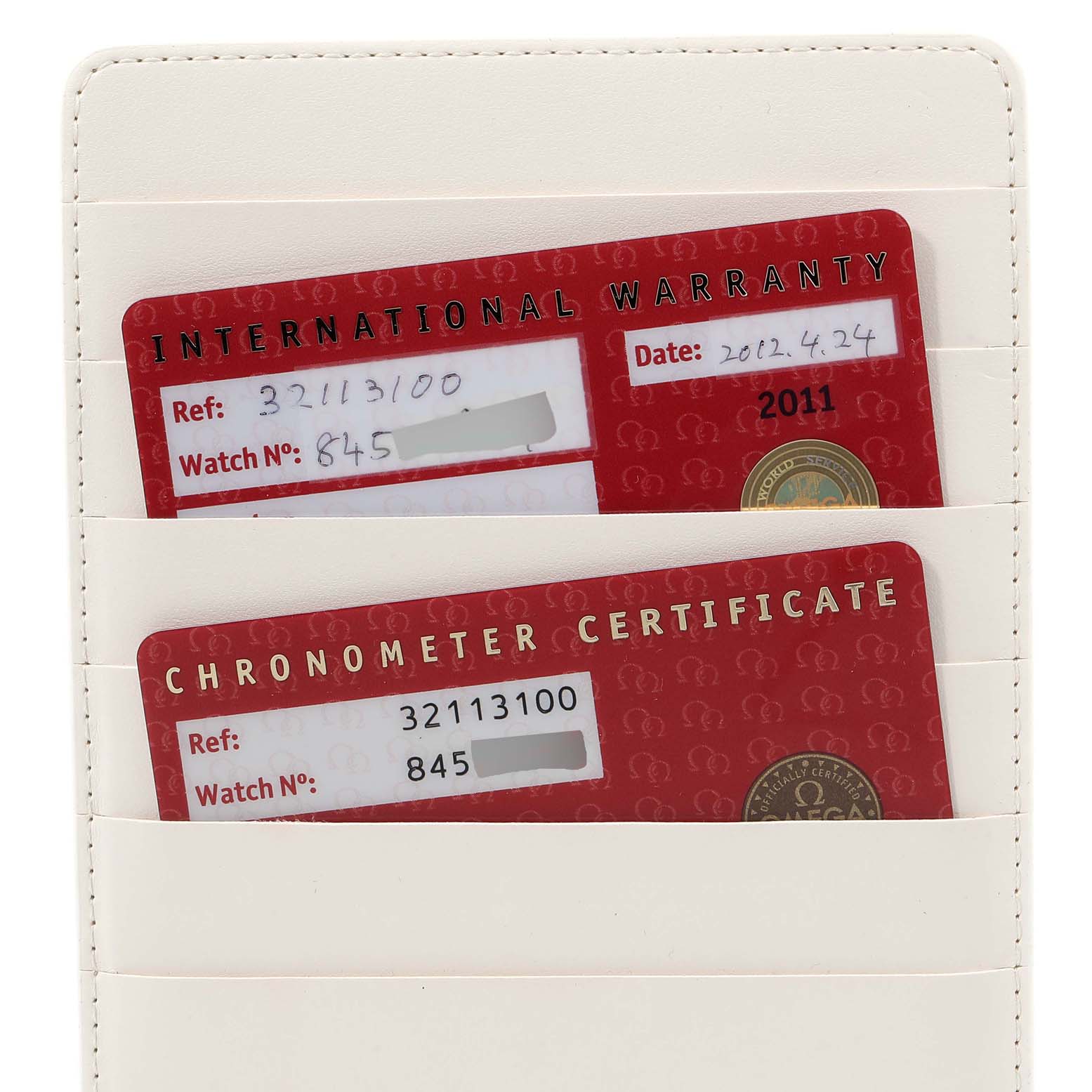 The image shows the warranty and chronometer certificate cards for an Omega Speedmaster 3211.31.00 Men
s Stainless Steel Silver Dial 3211.31.00 Men
s Stainless Steel Silver Dial watch, displayed in a card holder.