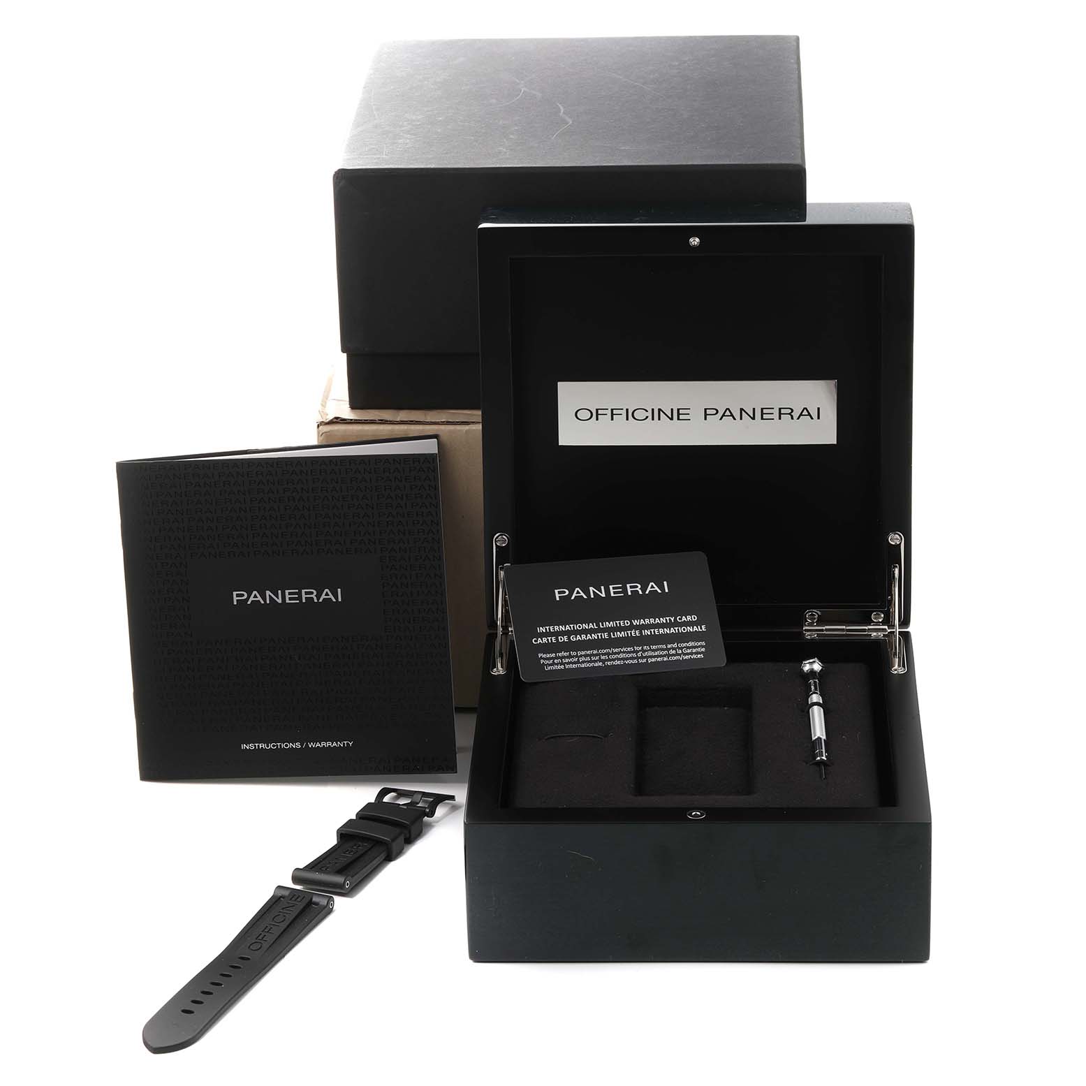 The image shows a Panerai Luminor PAM01118 Men's Titanium Black Dial PAM01118 Men's Titanium Black Dial watch box containing a warranty card, instruction manual, a spare strap, and a tool.