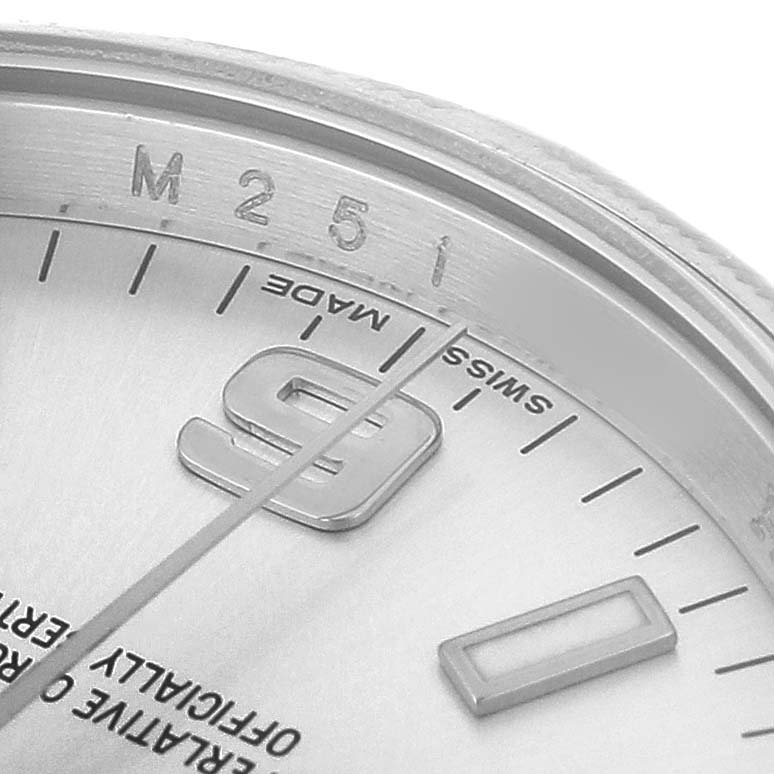 The image shows a close-up of the dial of a Rolex Air-King 114210 Men's Stainless Steel Silver Dial, focusing on the minute markers and a partial view of the 9 marker.